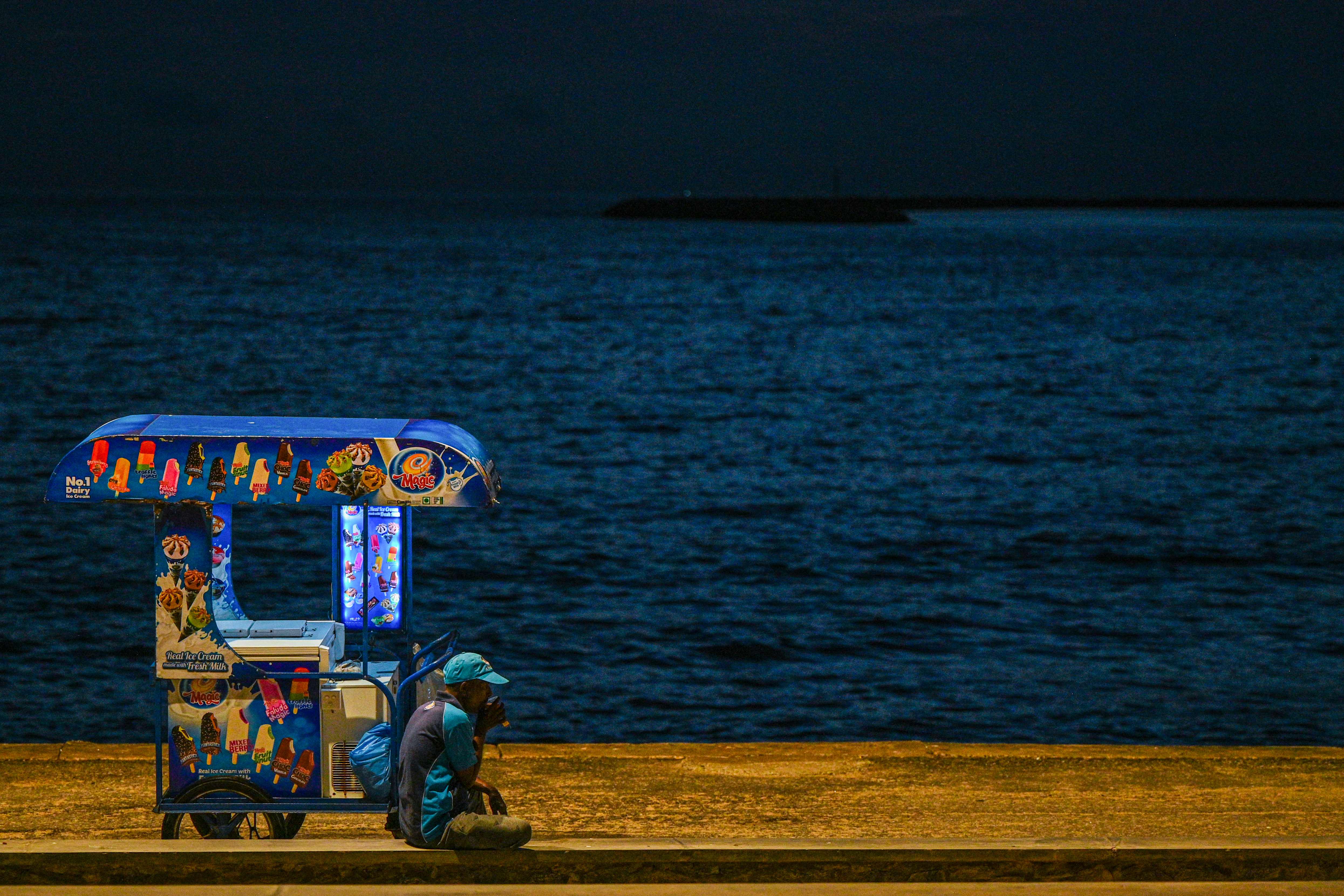 A vendor selling ice cream waits for customers at the Galle Face Beach in Colombo, Sri Lanka