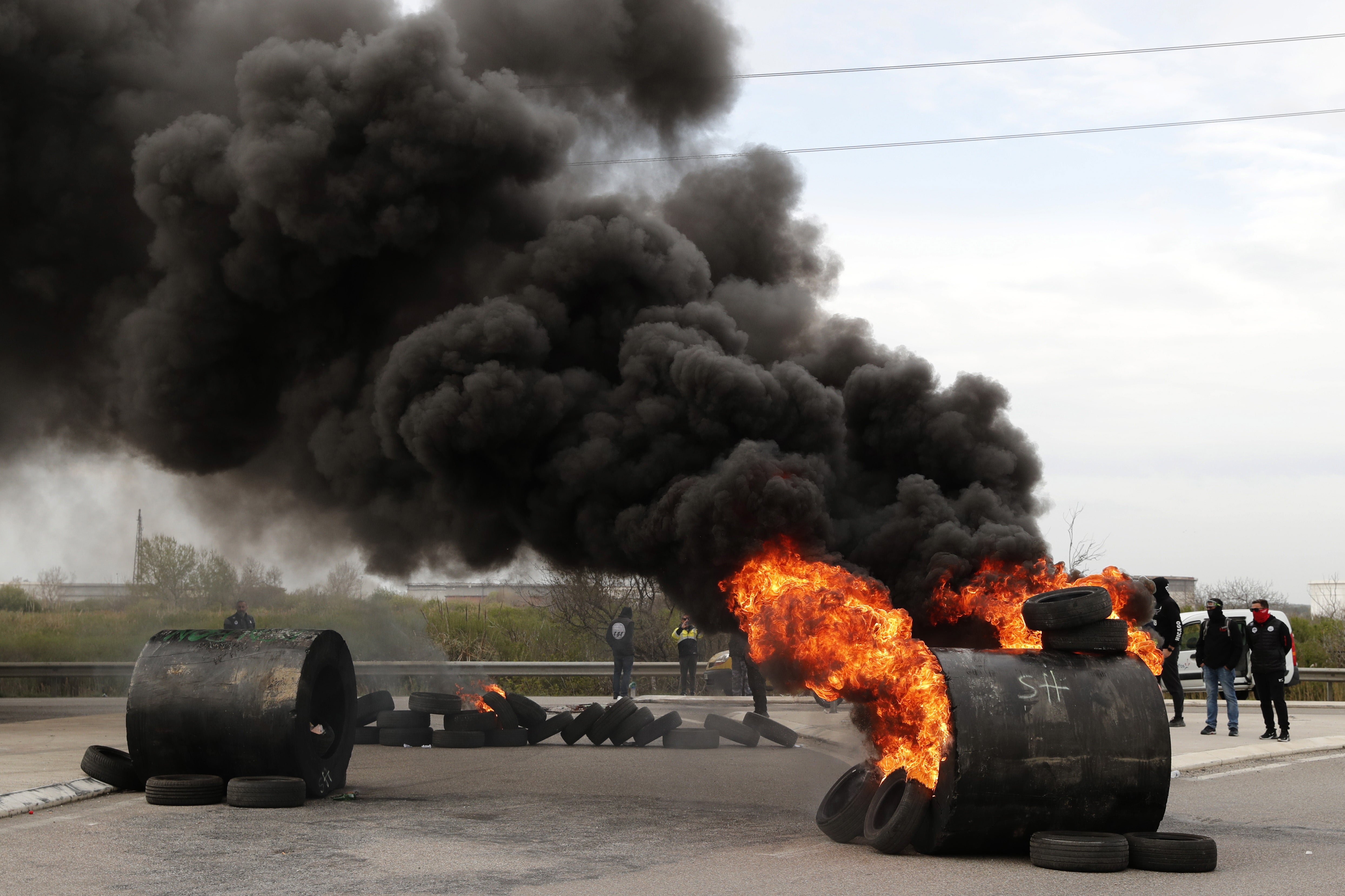 French union workers block access to the Fos-sur-Mer refinery during a protest against the French government's reform to the pension system, in Fos-sur-Mer, near Marseille