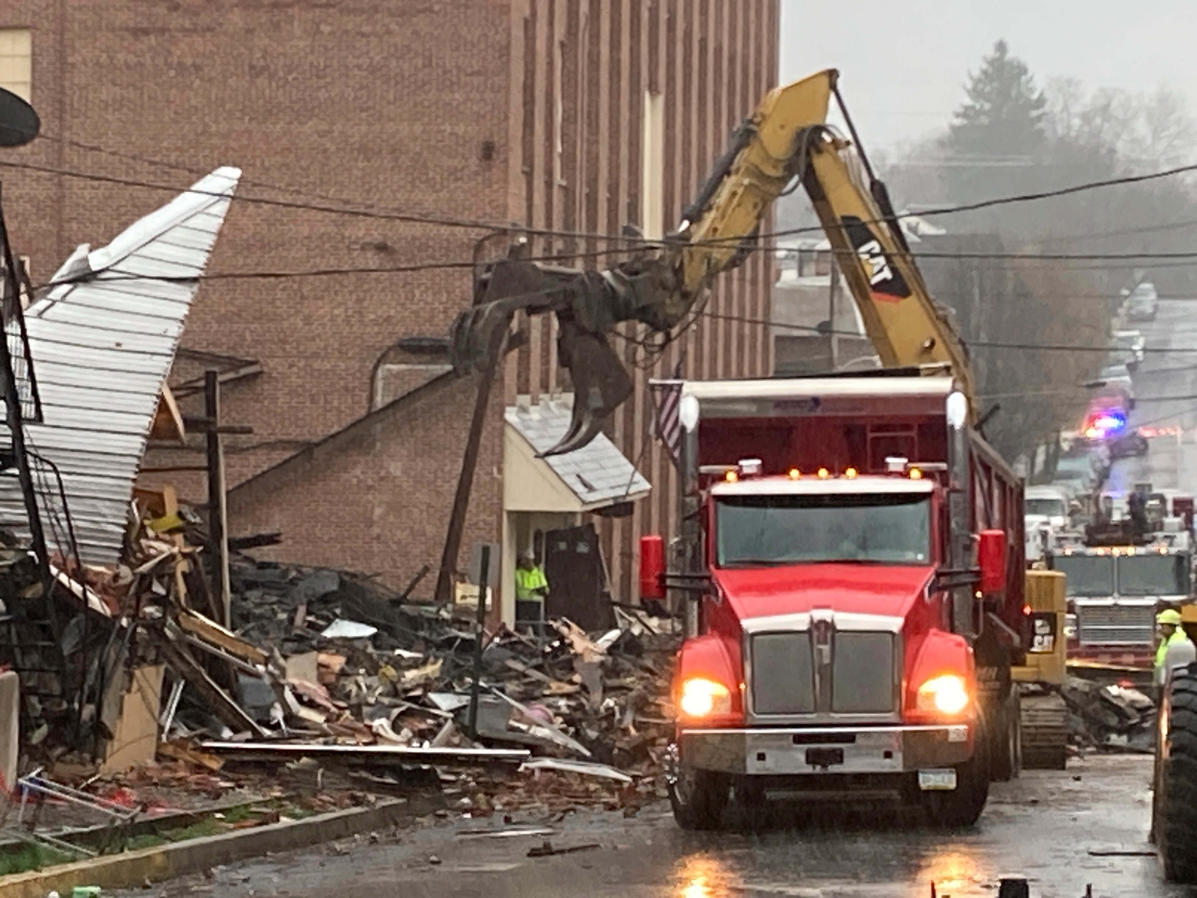 Rubble is cleared at the site of a deadly explosion at a chocolate factory in West Reading, Pa., Saturday, March 25, 2023