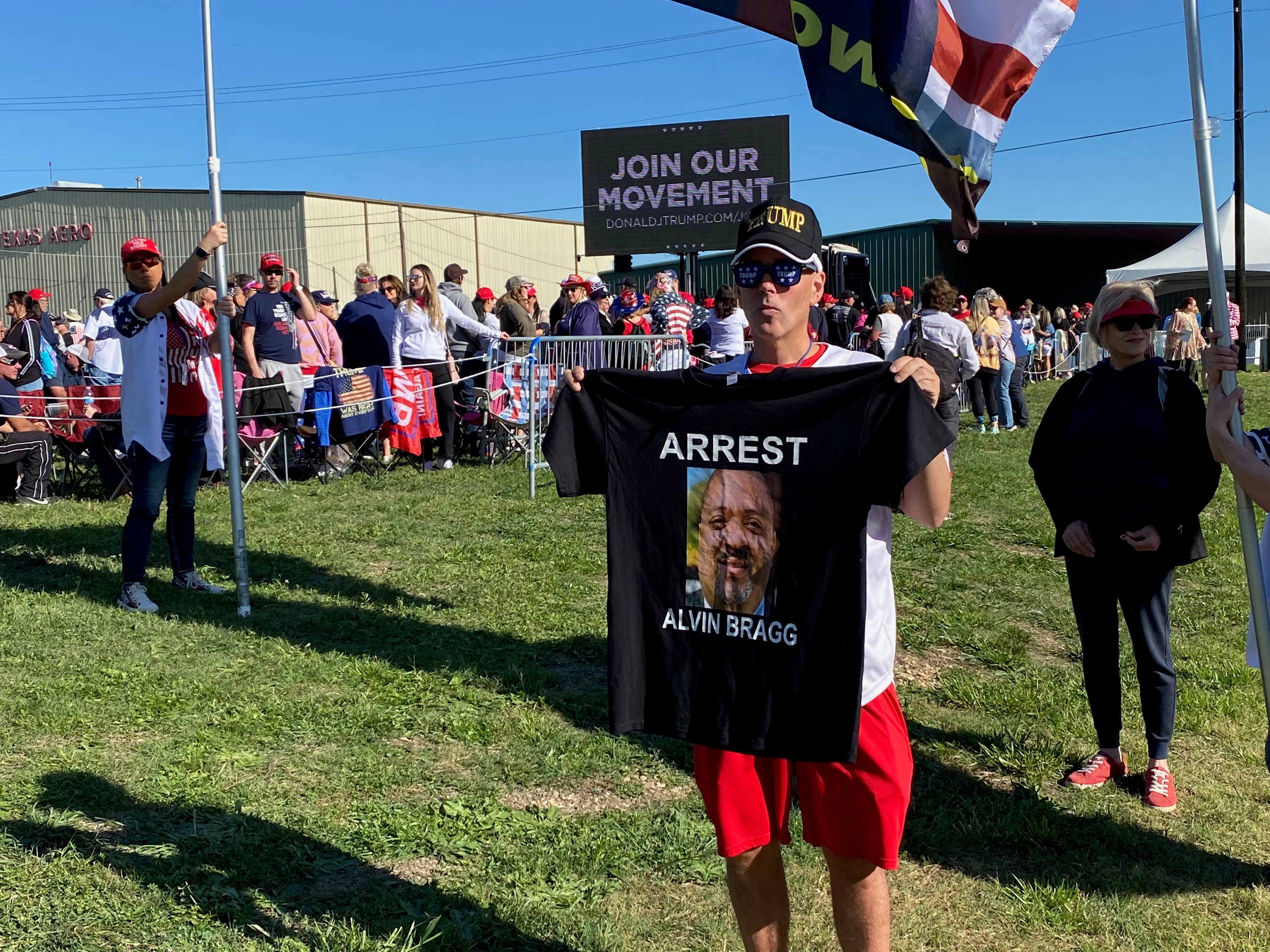 Man holds an ‘arrest Alvin Bragg’ t-shirt at the Trump rally in Waco, Texas