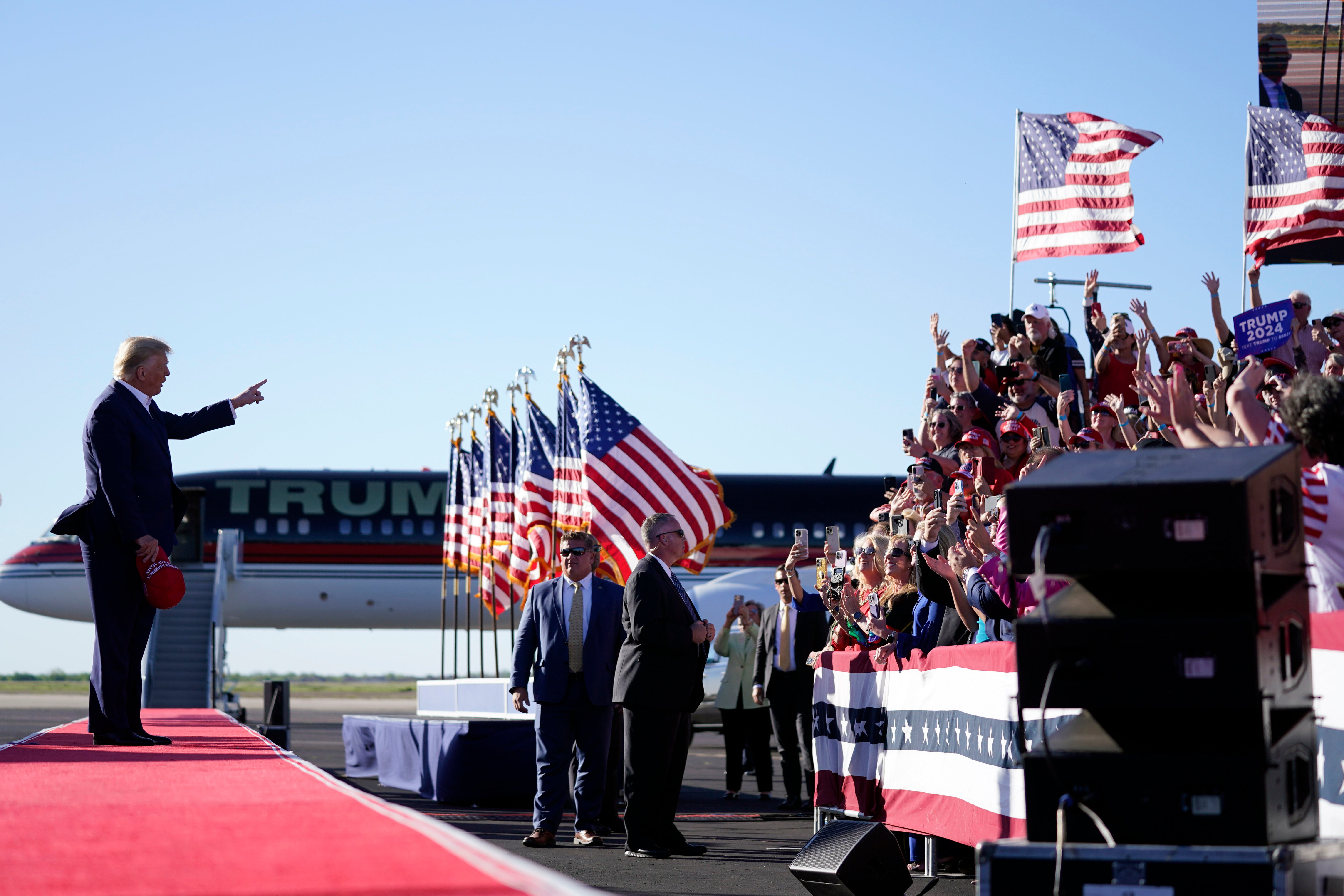 Former President Donald Trump points to supporters as he arrives to speak at a campaign rally at Waco Regional Airport, Saturday, March 25, 2023