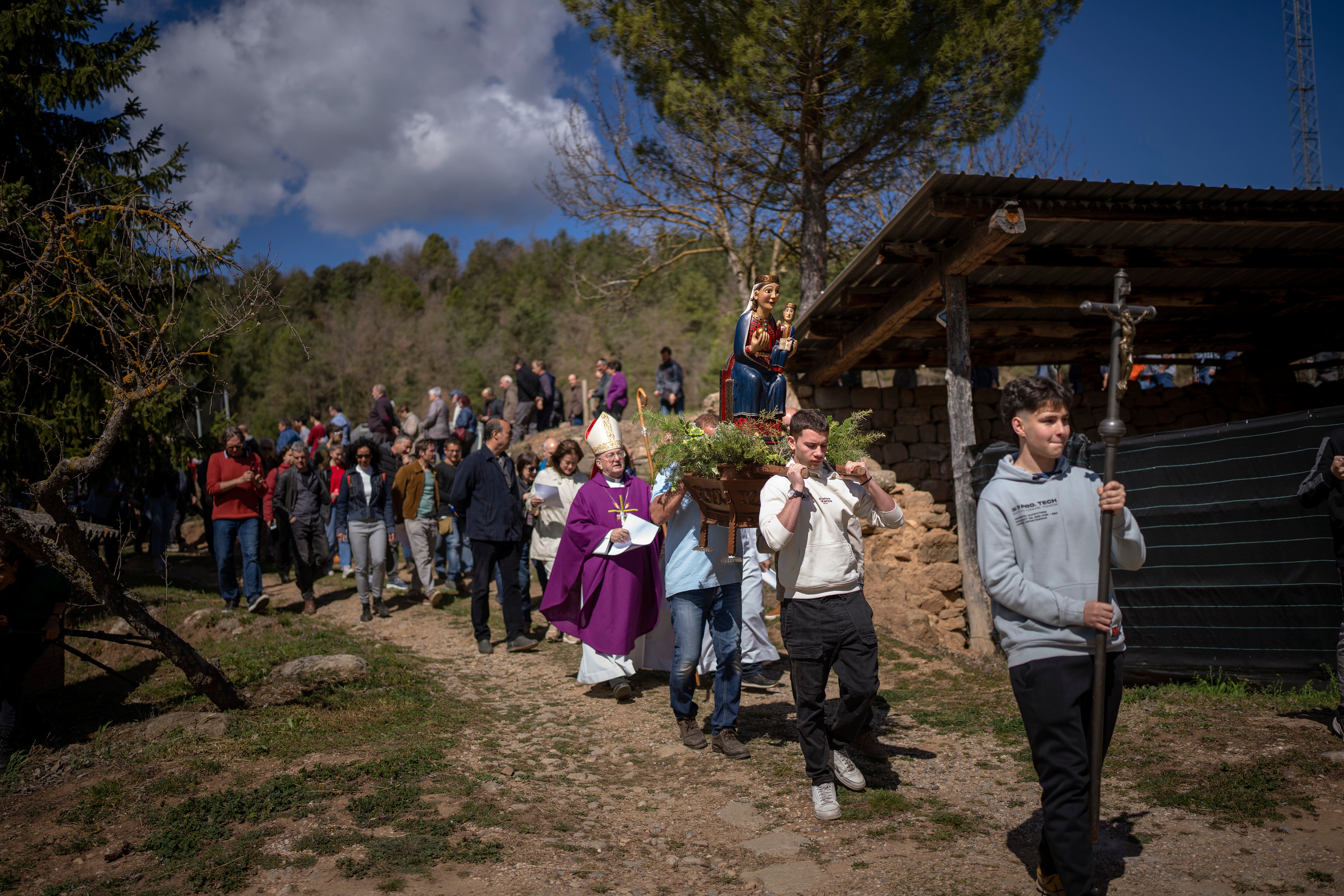 Residents take part in a procession carrying a replica of the Our Lady of the Torrents, a virgin historically associated with drought, in l'Espunyola Spain