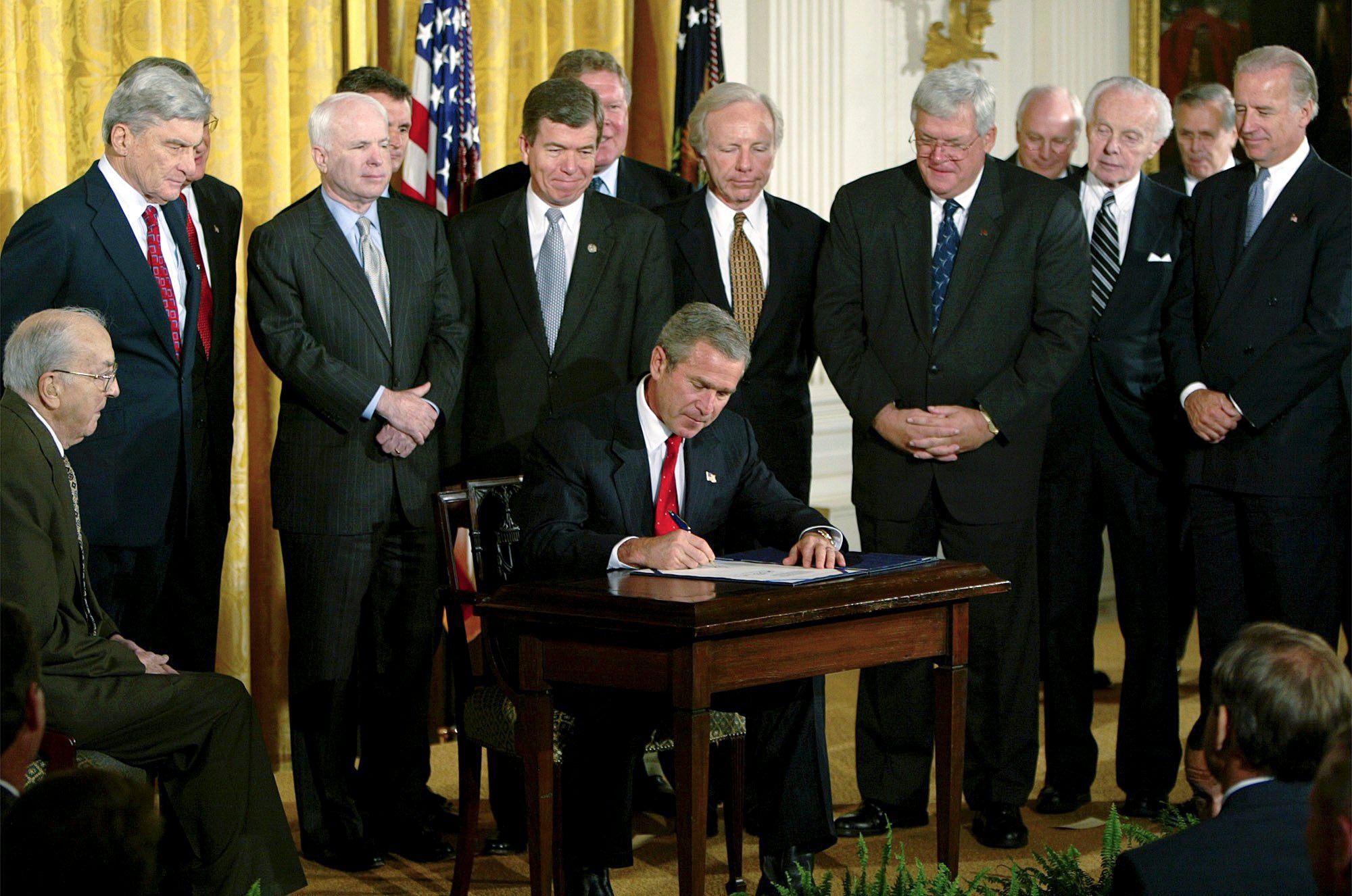 President George W. Bush signs a resolution authorizing the use of force against Iraq, Oct. 16, 2002