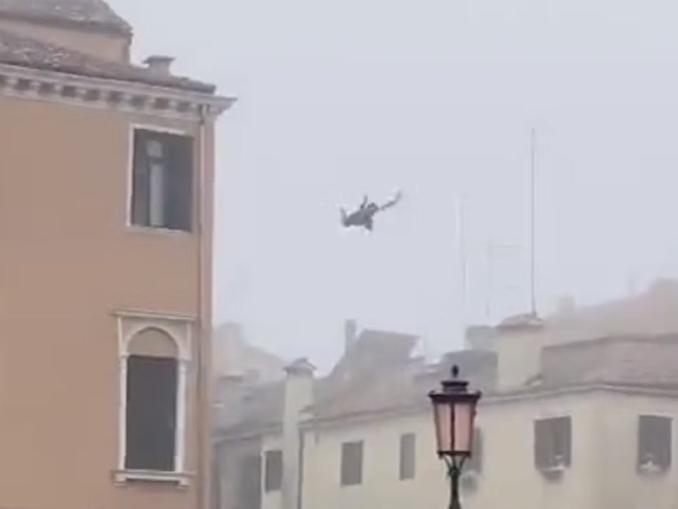 A screengrab of the person flying through the air into the canal