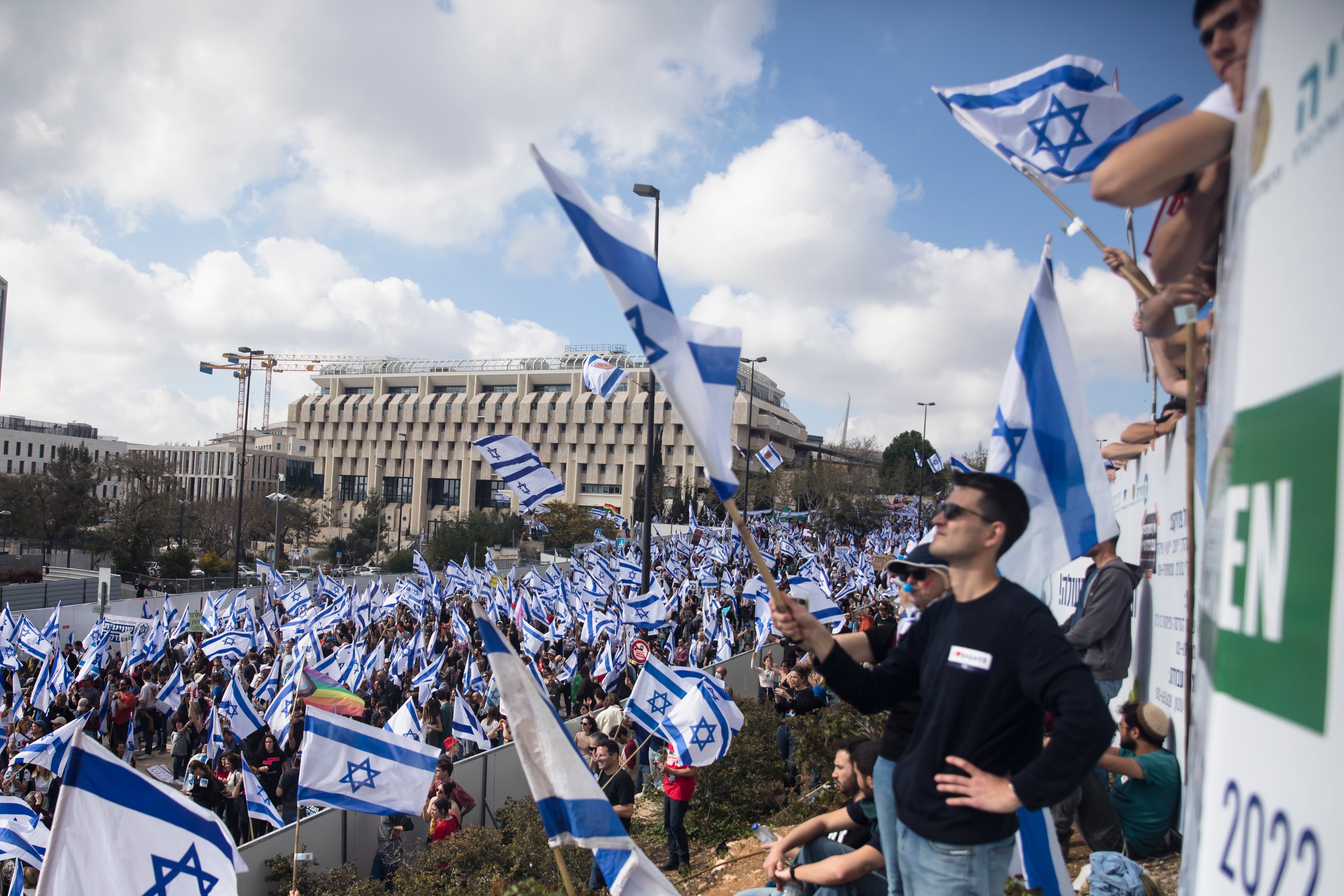 Protestors wave flags in Jerusalem on 27 March 2023