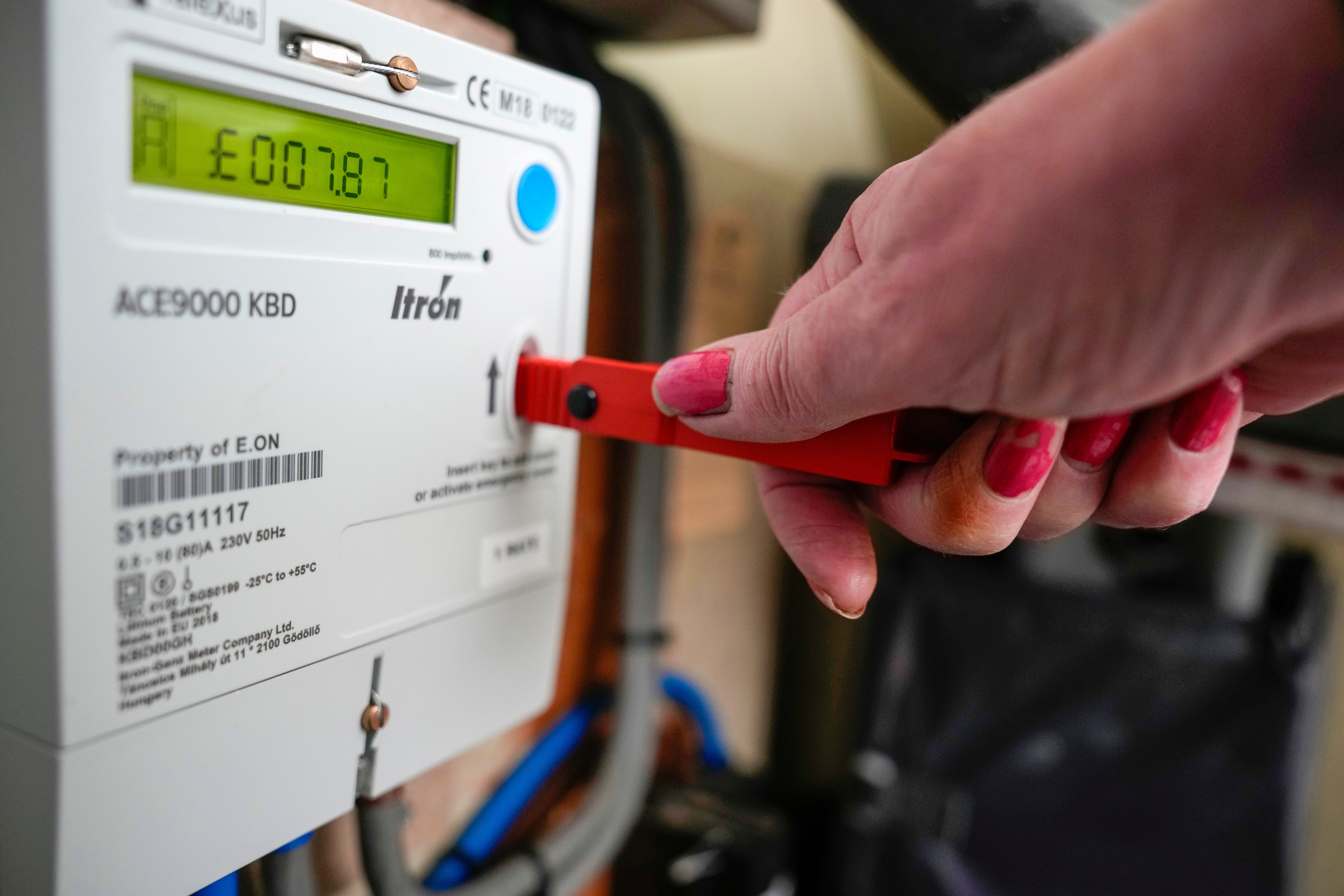 File photo: A woman tops up a prepayment meter