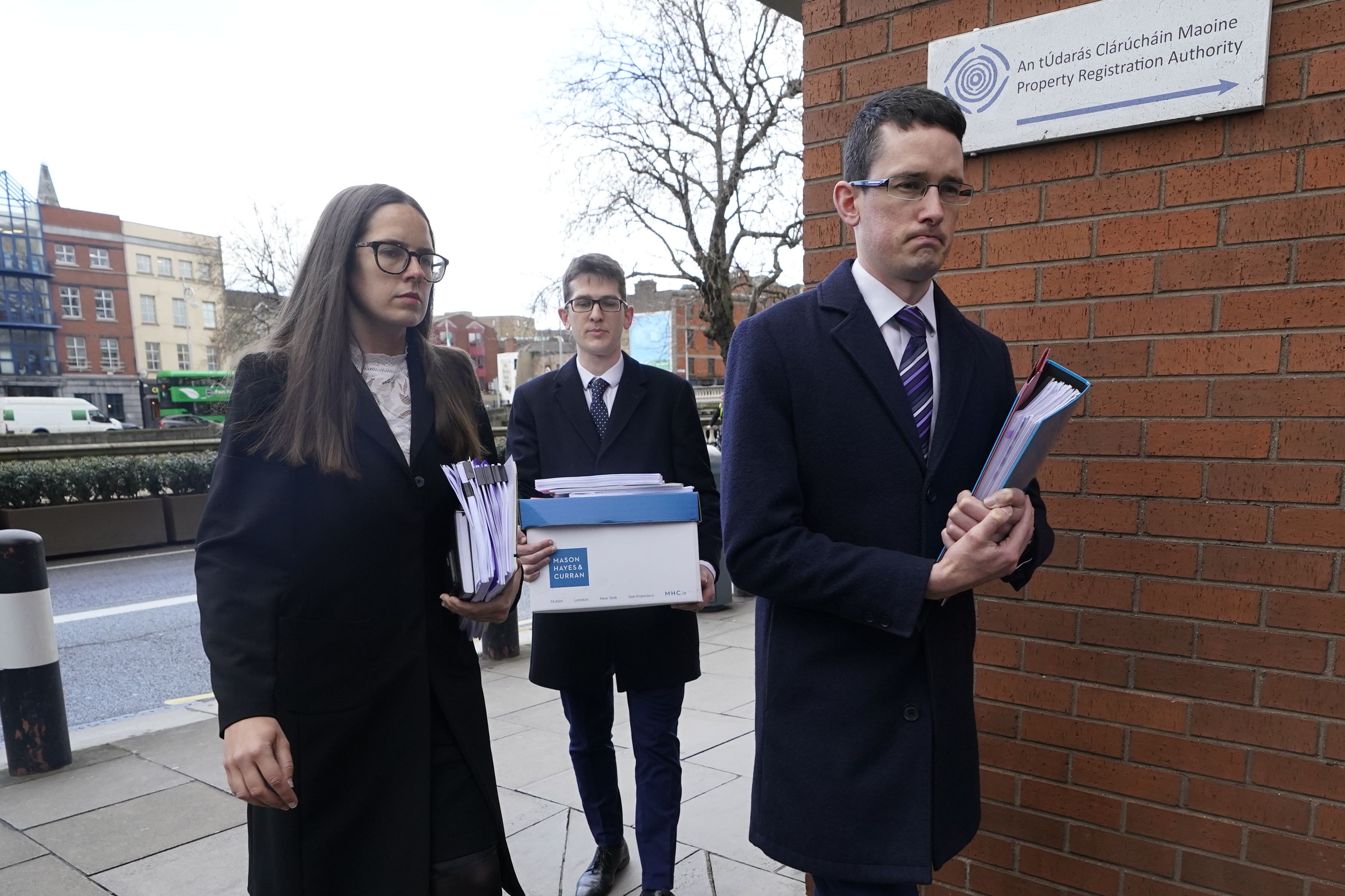 Irish teacher Enoch Burke (right), his sister Ammi Burke, and brother Isaac Burke (back) arriving at the High Court in Dublin for the legal case between Mr Burke and Wilson’s Hospital School (PA)