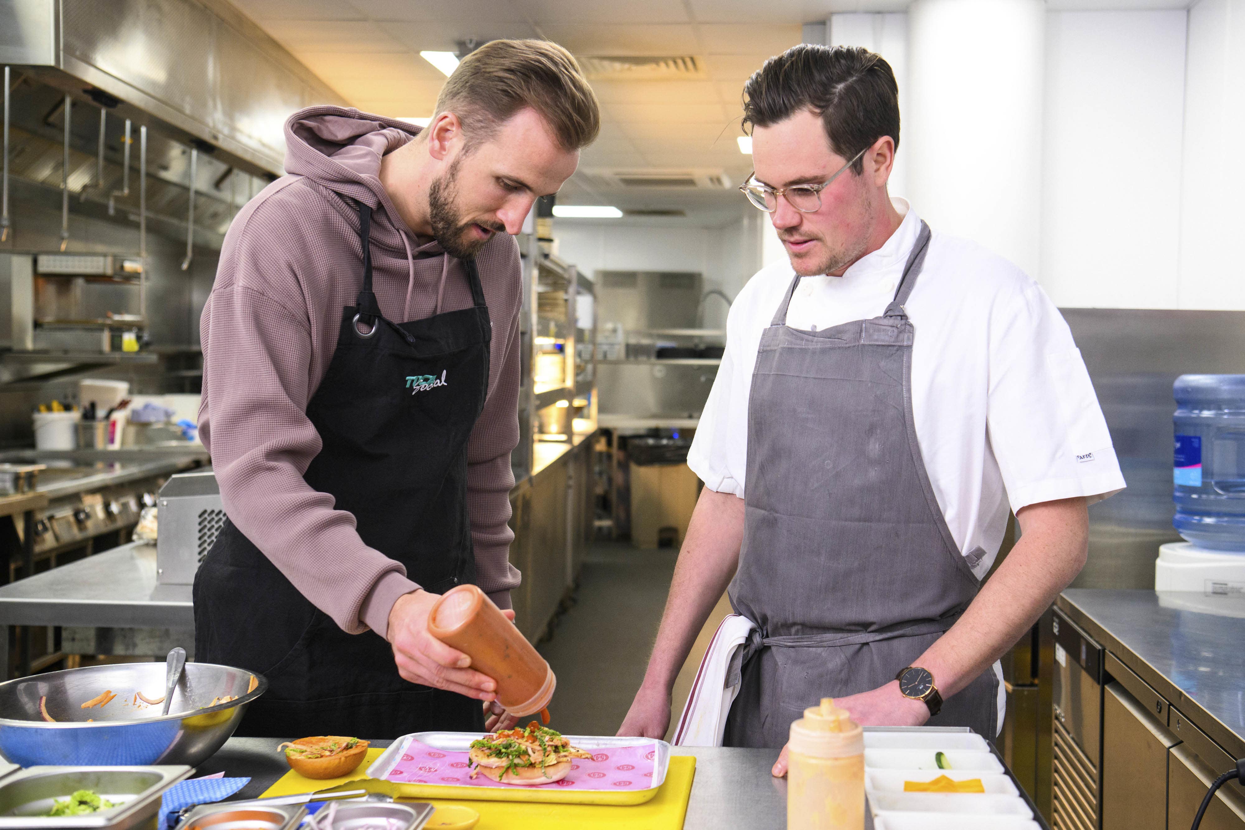 EDITORIAL USE ONLY England captain Harry Kane prepares a limited-edition burger called ‘The Record Breaker’ at TOCA Social at The O2, London, which has been created using his favourite ingredients to celebrate him becoming England’s all-time record goal scorer, following his goal against Italy last Thursday. Issue date: Tuesday March 28, 2023.