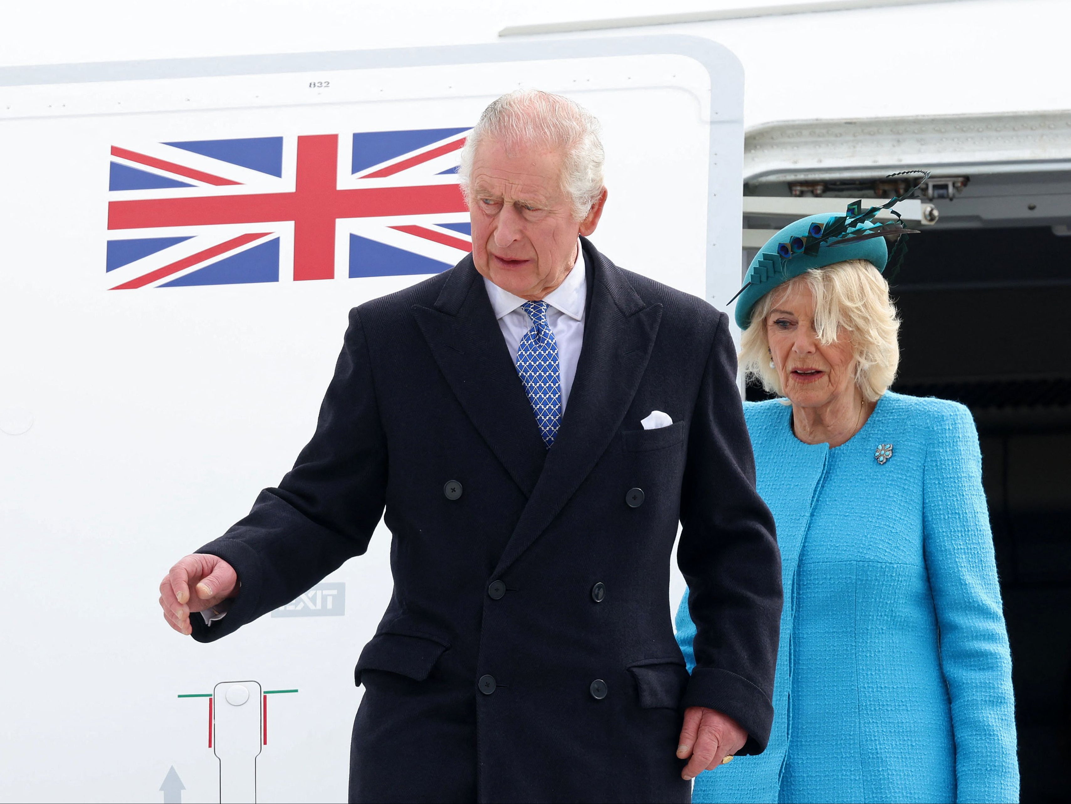 King Charles and Camilla, Queen Consort disembark their plane after landing at Berlin Brandenburg Airport