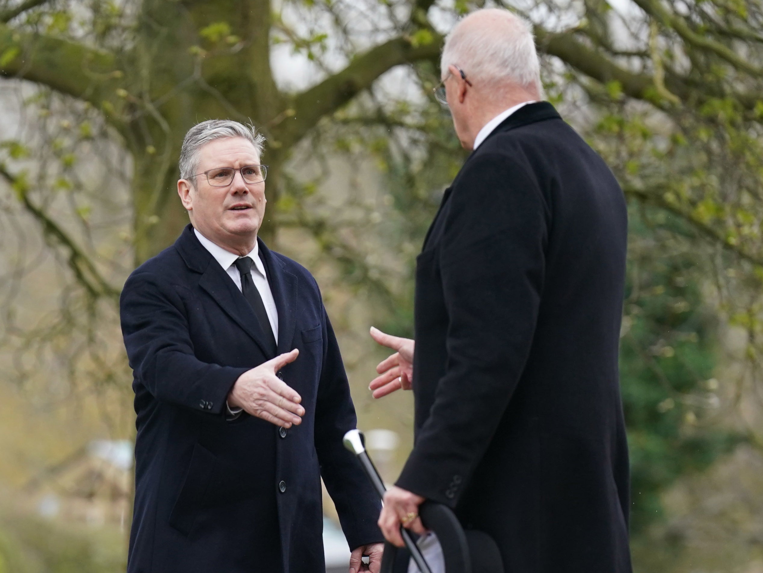 Sir Keir greeted other funeral-goers