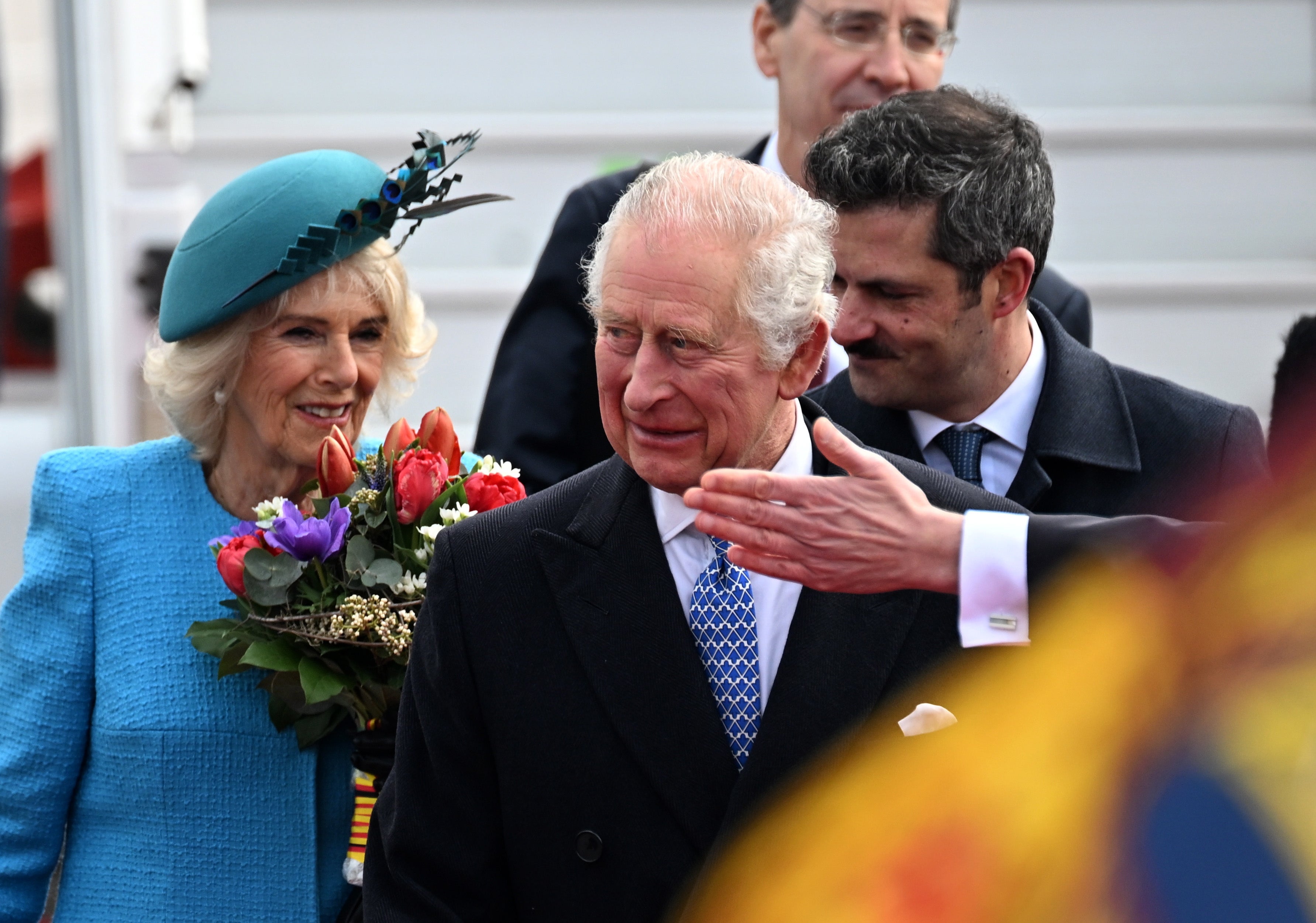 Charles and Camilla are greeted at the airport