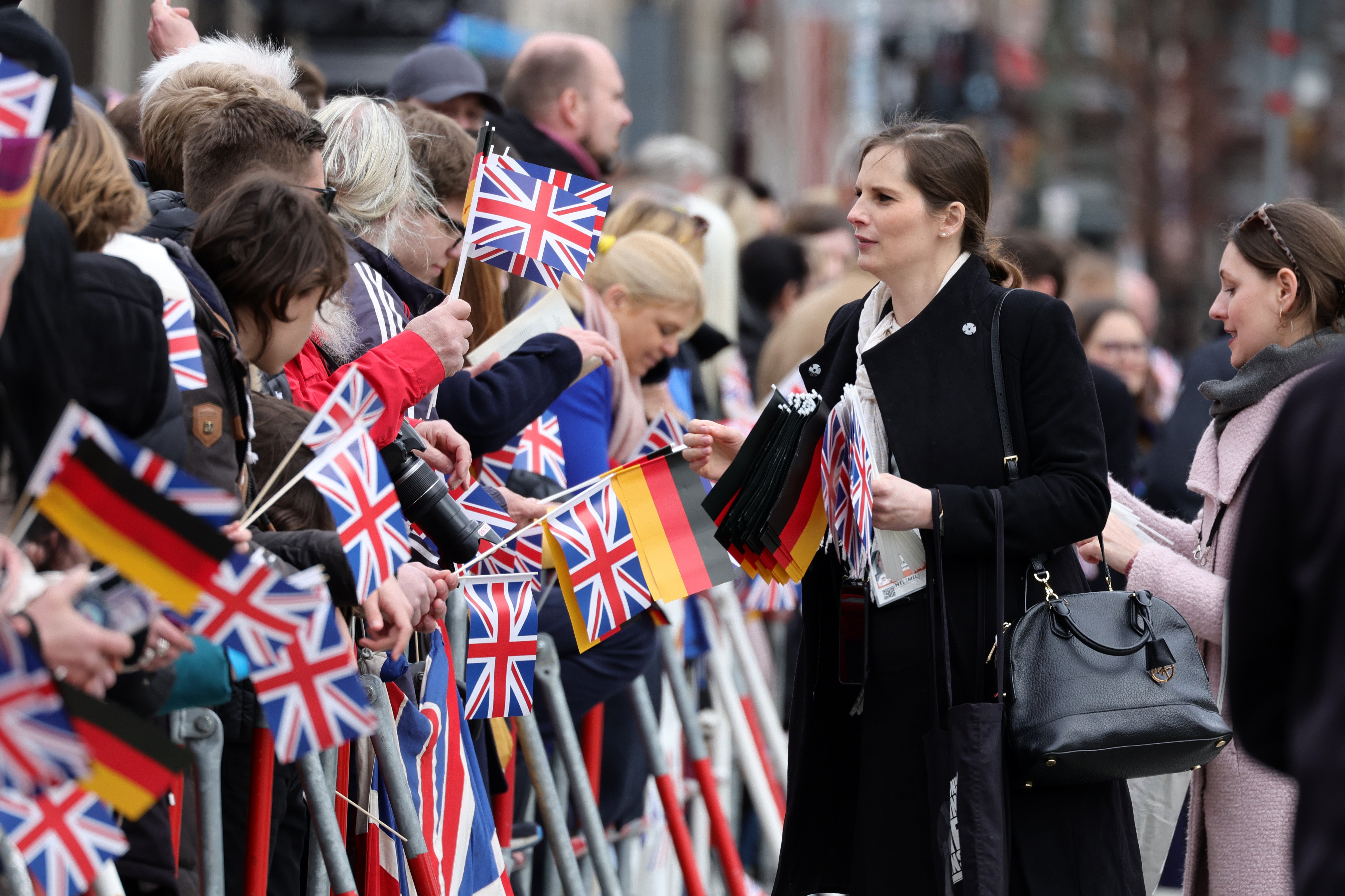 Crowds of Royalists were at the airport to greet Charles and Camilla on their first state visit