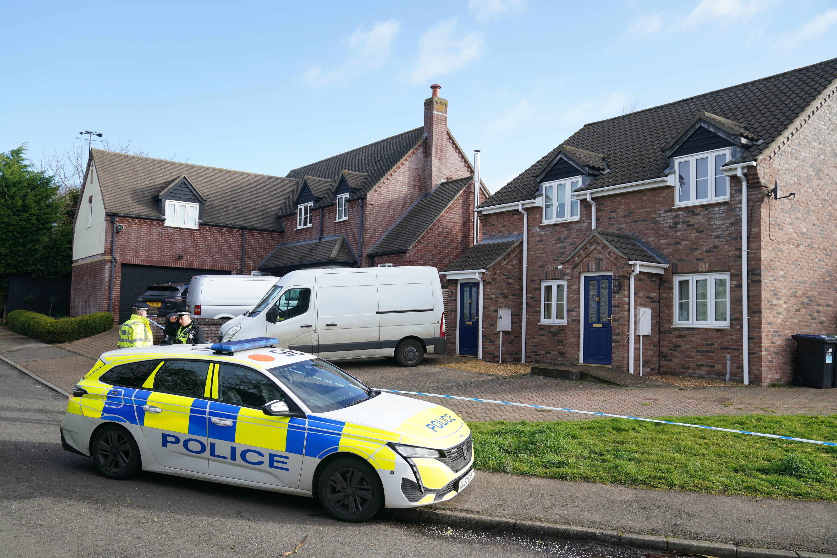 Police at the scene in The Row in Sutton, near Ely, Cambridgeshire