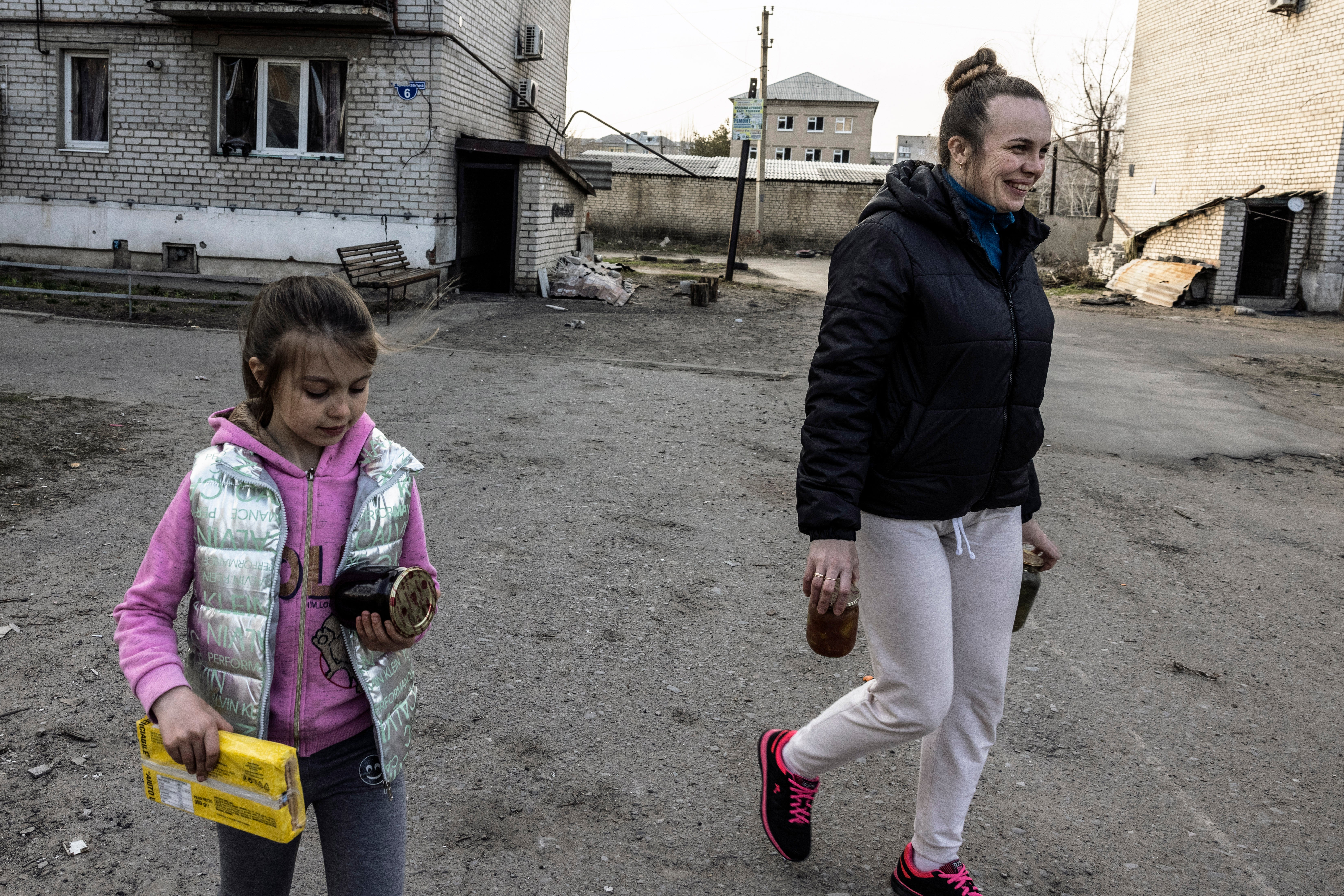 Anastasiya and her mother, Iryna, return home with jars of jam and pickles