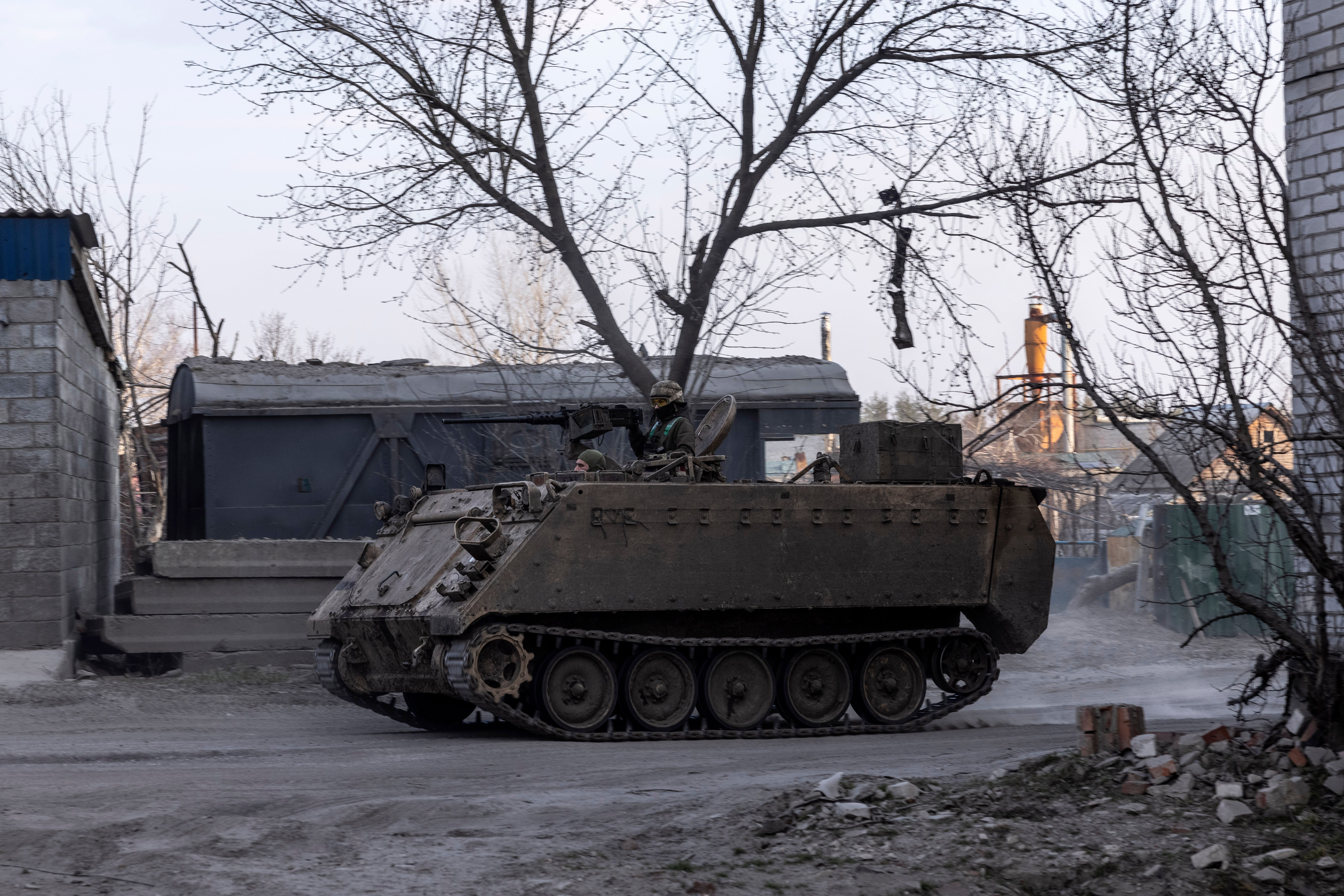 Ukrainian soldiers drive past the Triangle