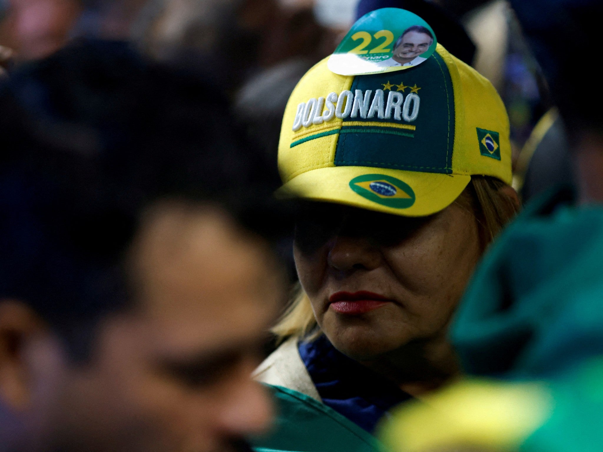 Supporters of Jair Bolsonaro wait to greet his return