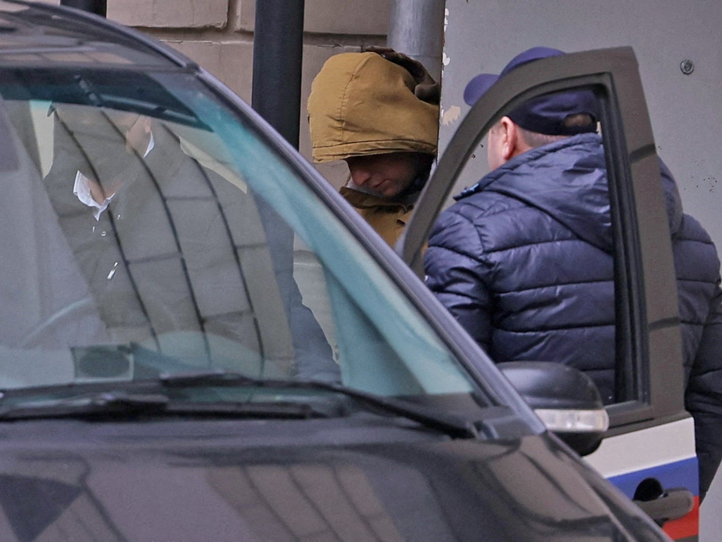 Evan Gershkovich leaves the court building in Moscow