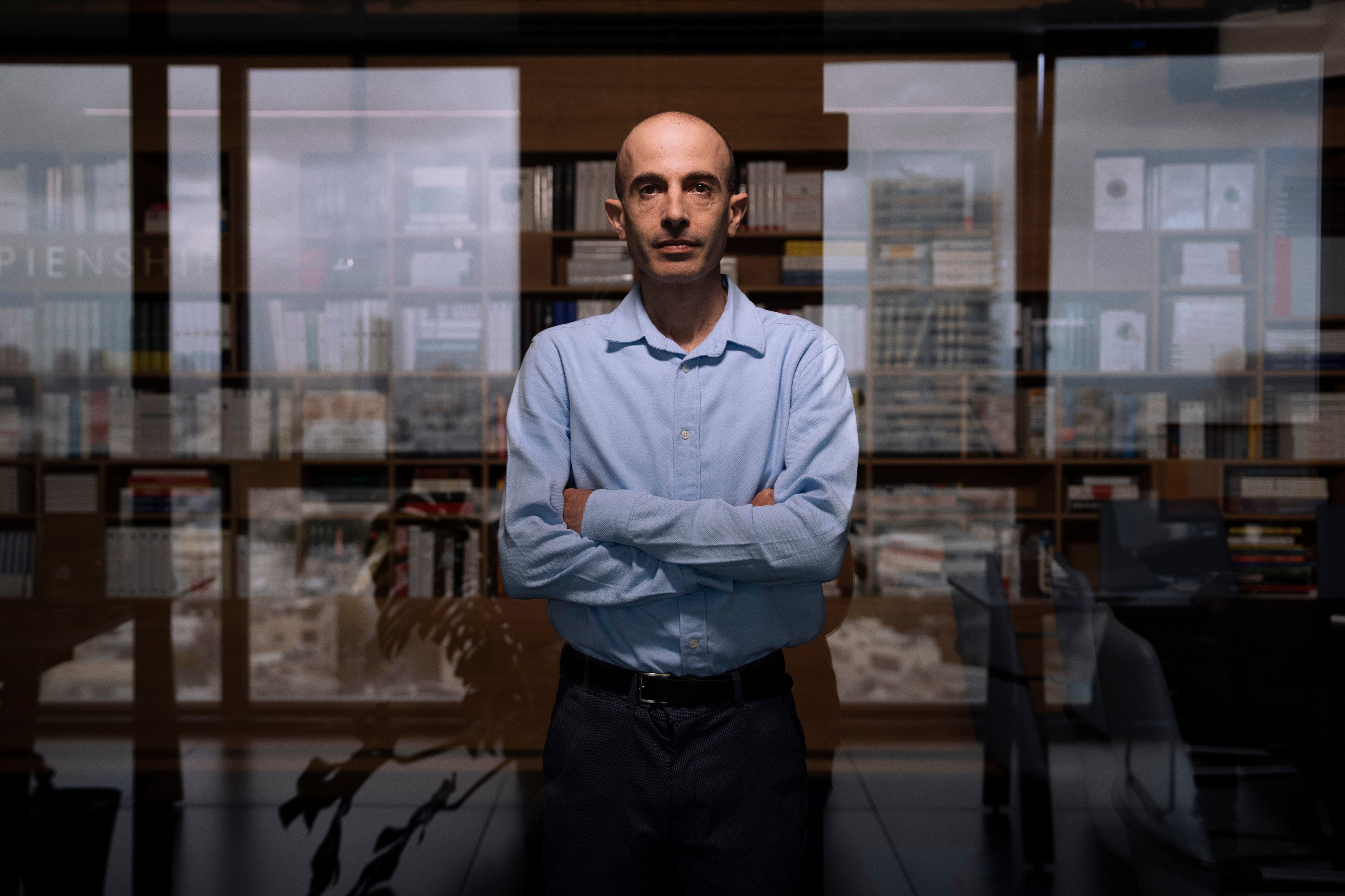 Yuval Noah Harari stands outside his office