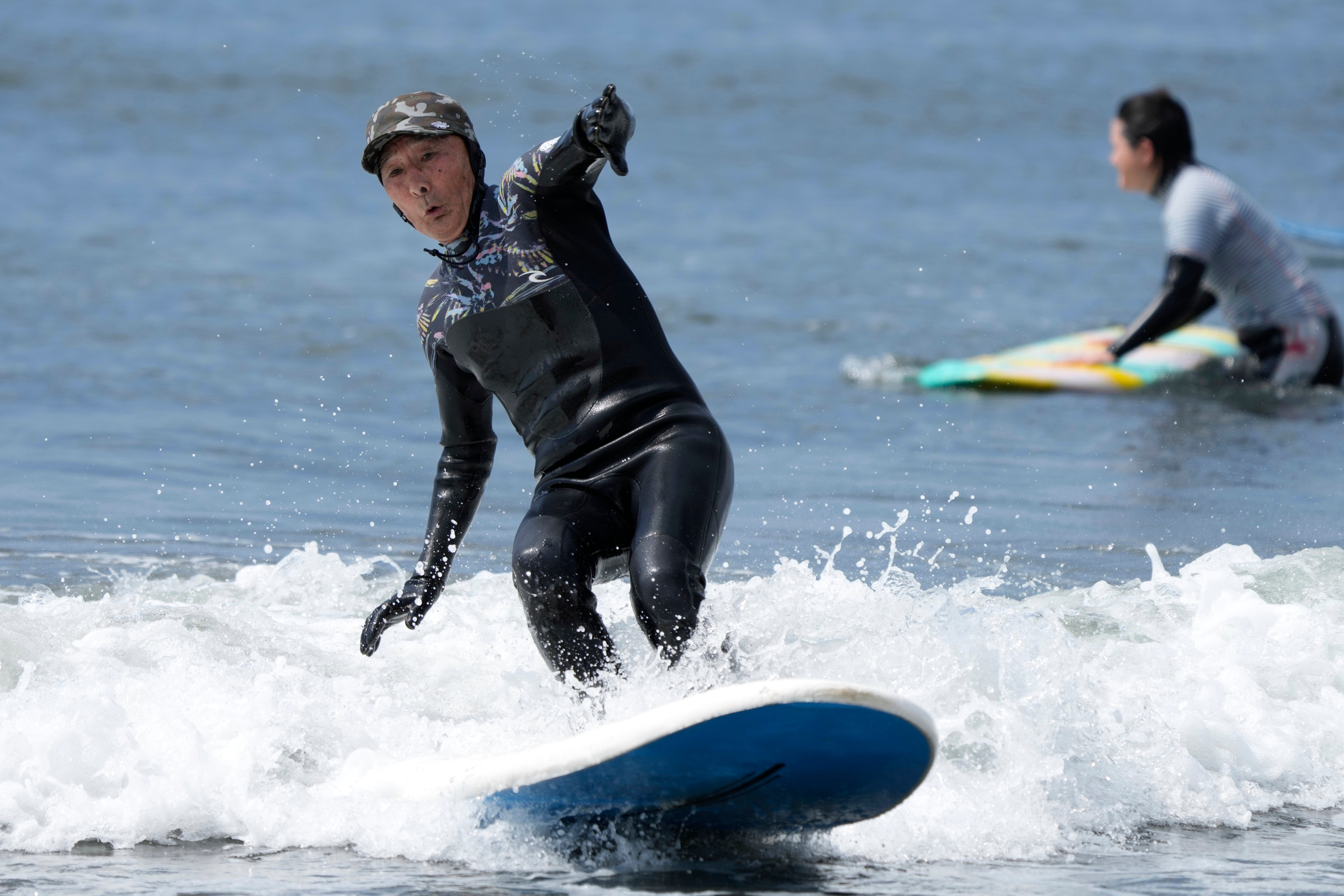 Seiichi Sano, an 89-year-old Japanese man, rides a wave at Katase Nishihama Beach in Japan