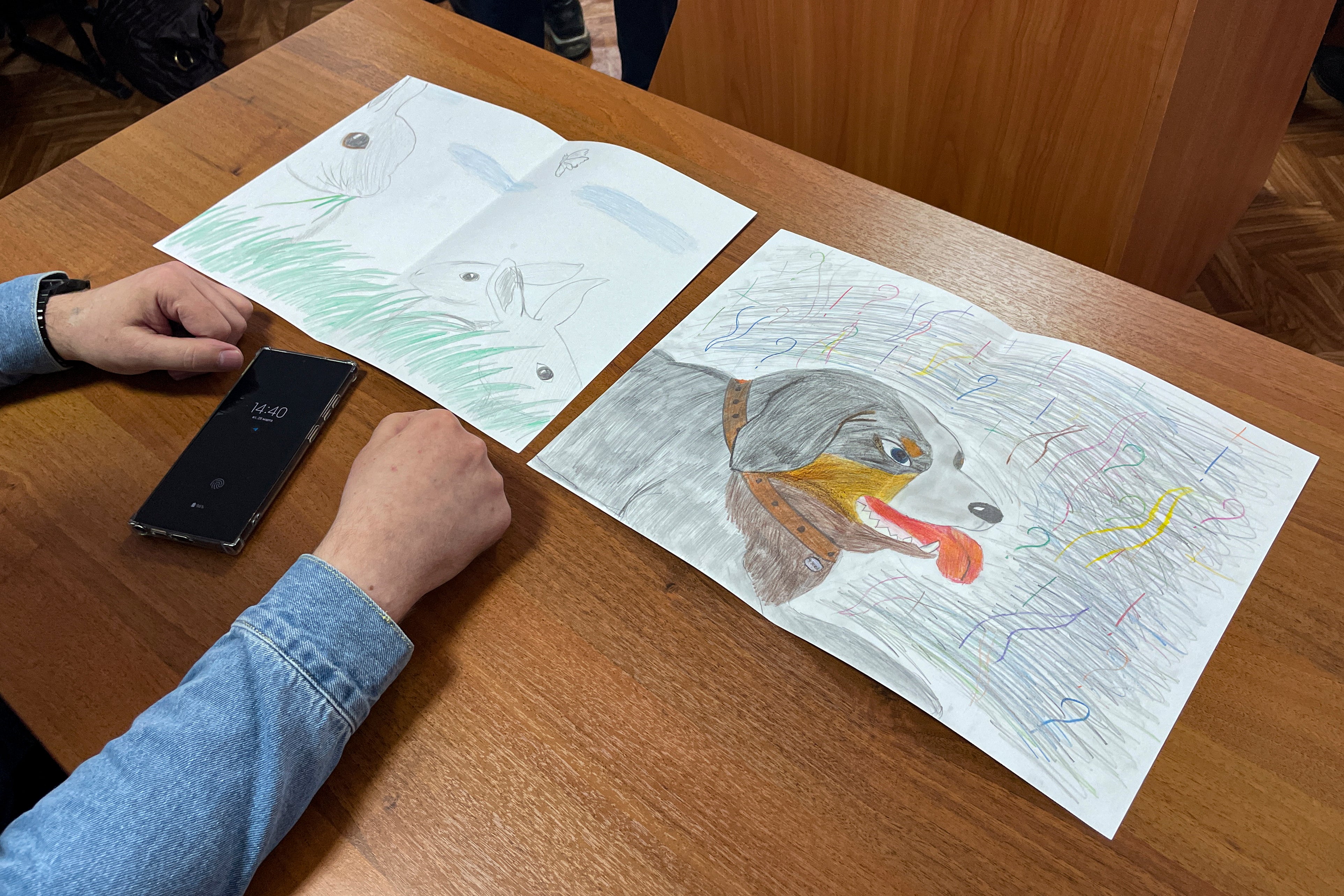 Moskalyov's lawyer Vladimir Biliyenko shows drawings that Maria Moskalyova, daughter of Alexei Moskalyov, drew for her father in a courtroom in Yefremov