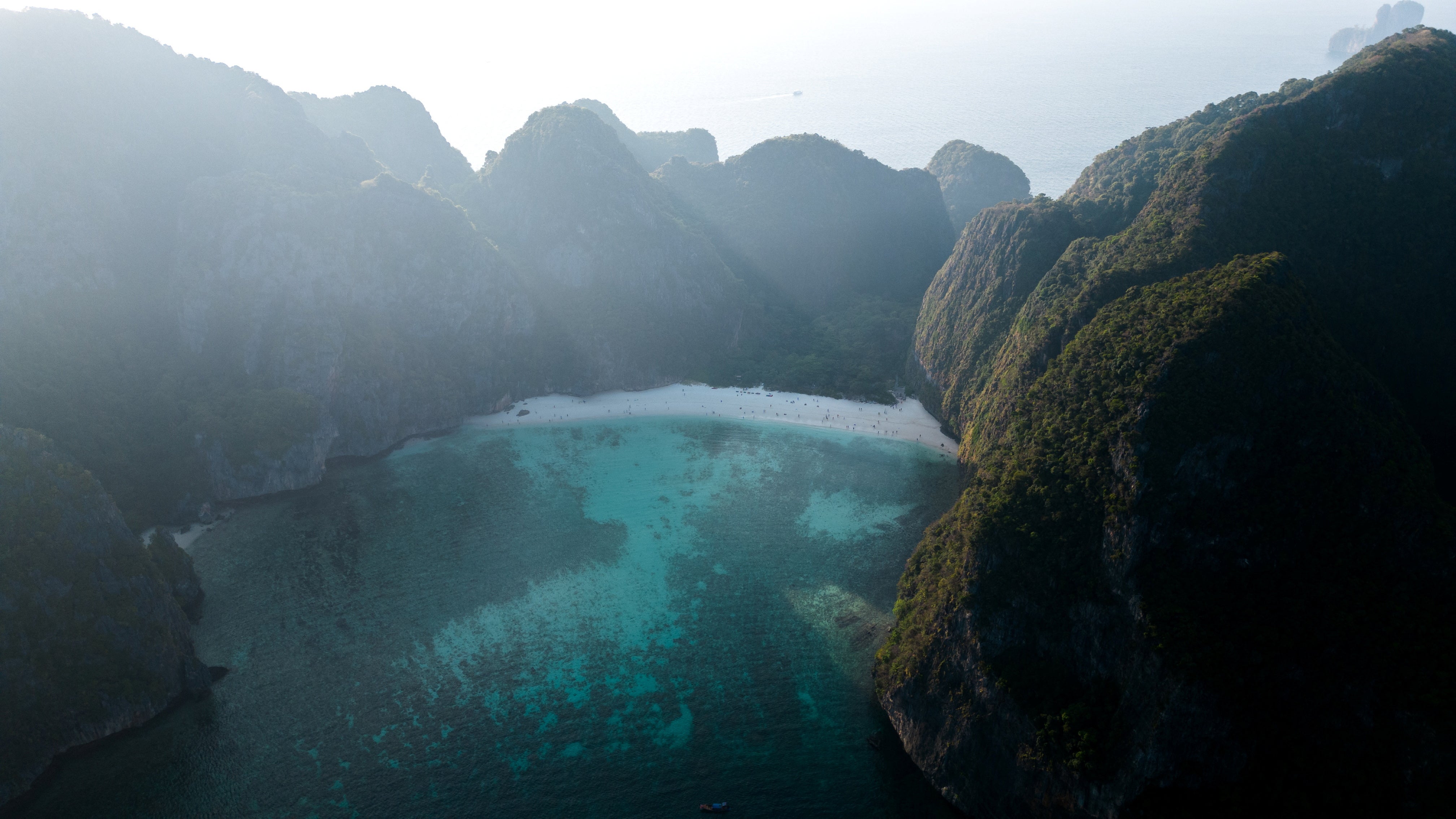 The sun rises over Maya Bay's limestone mountains at the Phi Phi Island