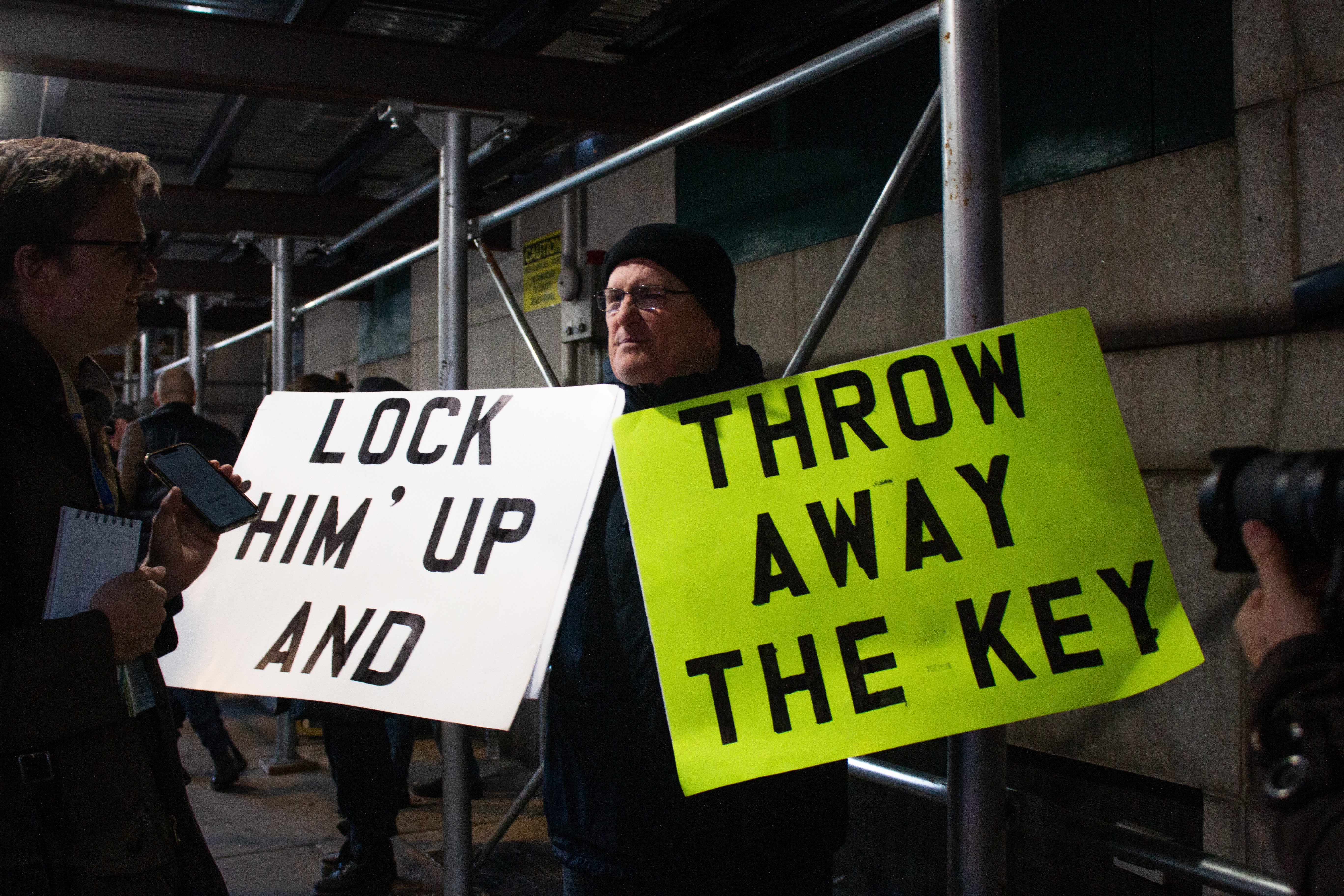 Outside of the courthouse, a protester advocates in favor of the Trump indictment