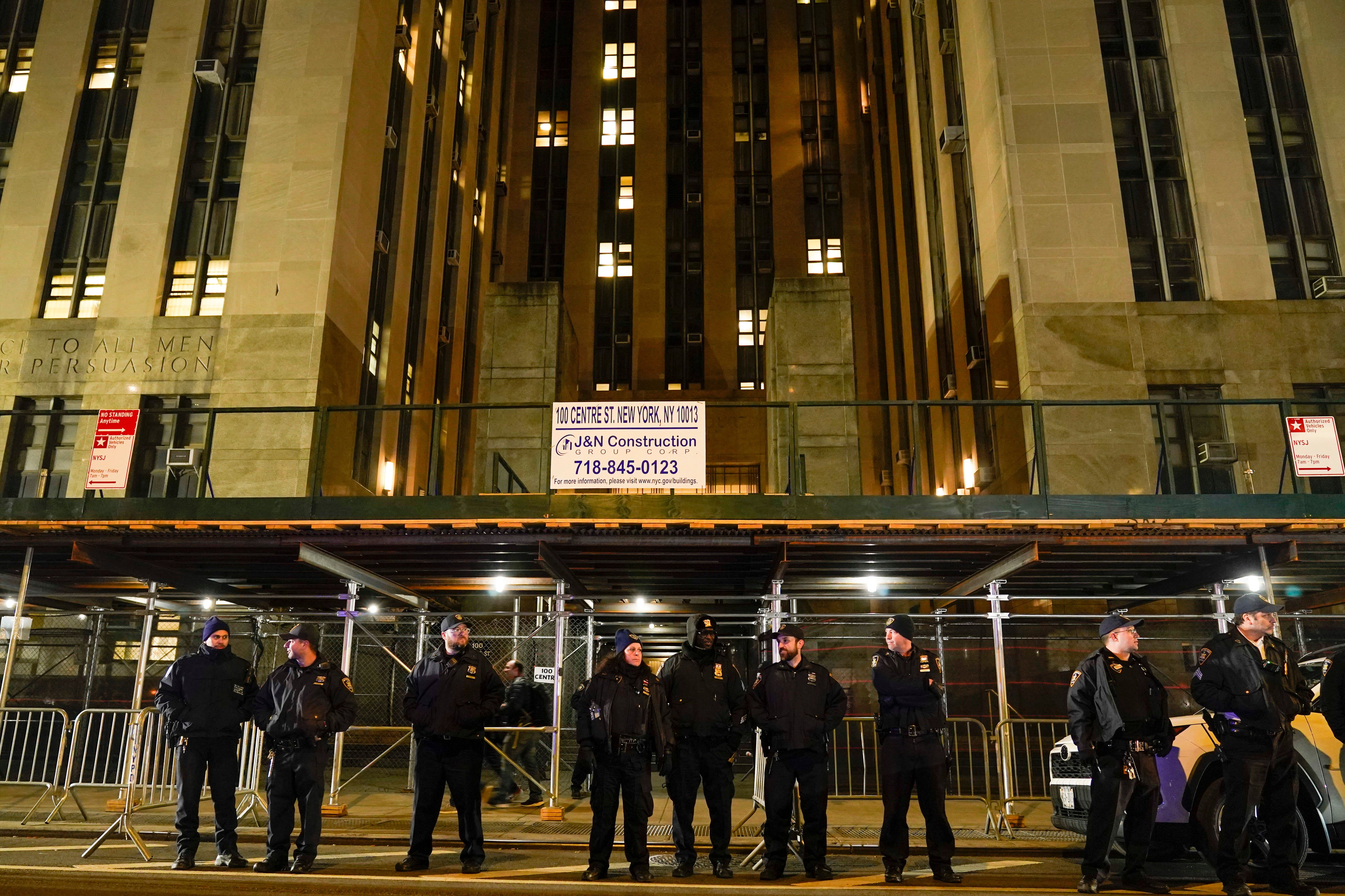 Court officers stand guard outside the Manhattan criminal courts building, Thursday, March 30, after Trump was indicted