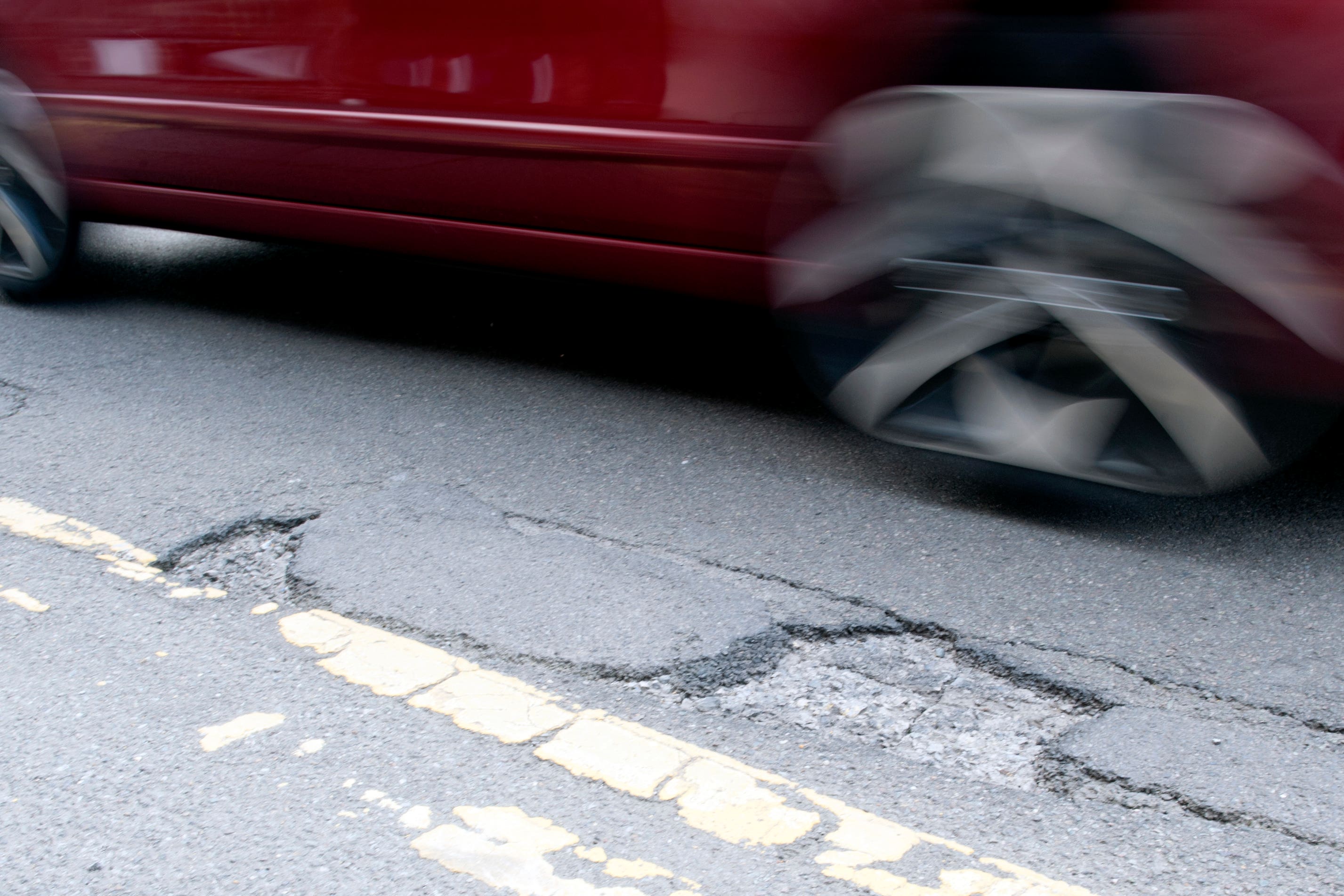 The government will fine utility firms for poor road repairs. (PA)