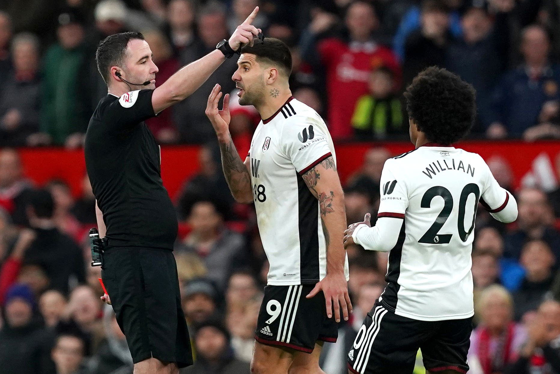 Aleksandar Mitrovic (centre) shoved referee Chris Kavanagh (left) and was sent off at Old Trafford (Martin Rickett/PA)