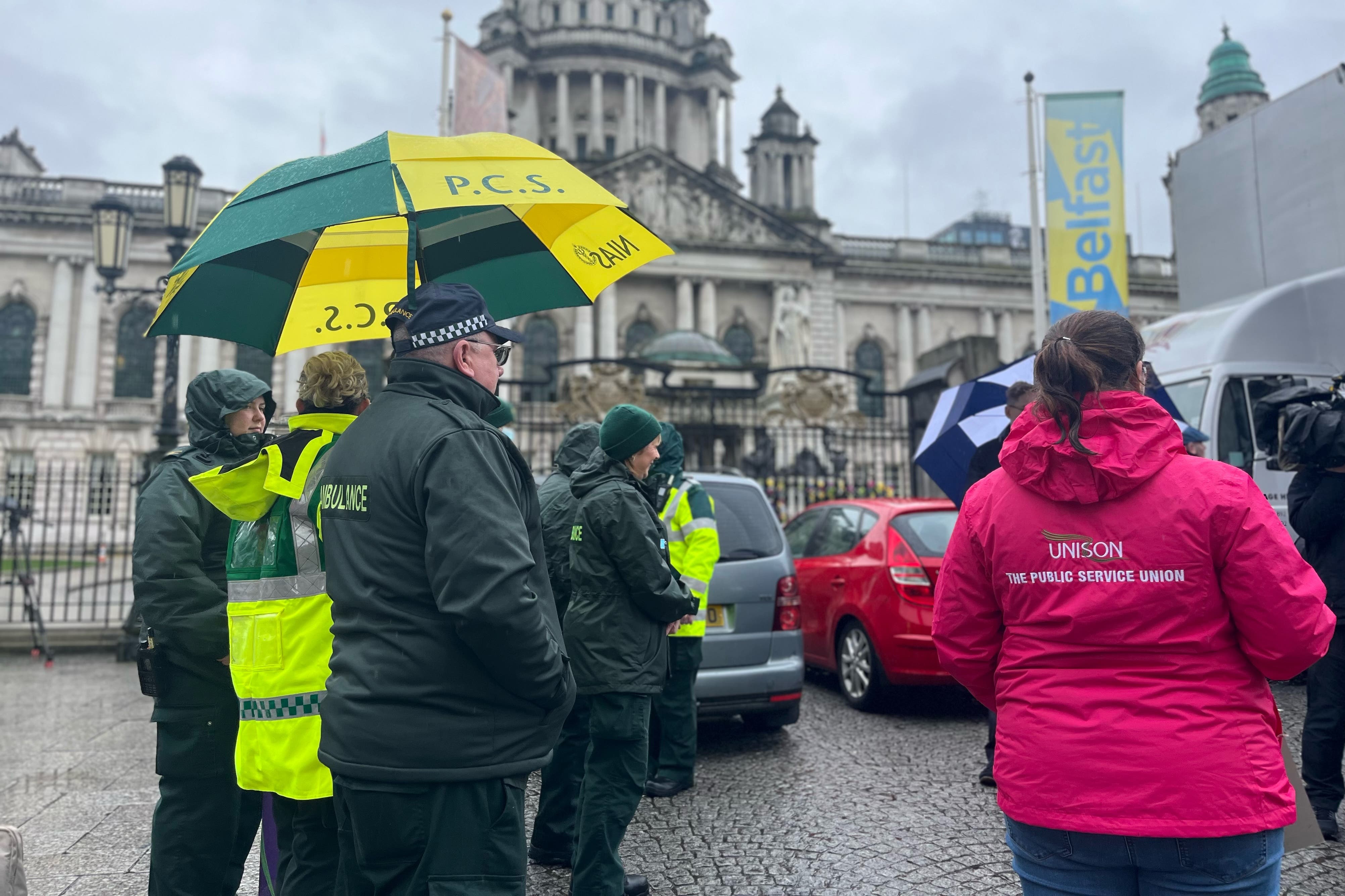 Unison and NIPSA workers on strike outside City Hall in Belfast (PA)