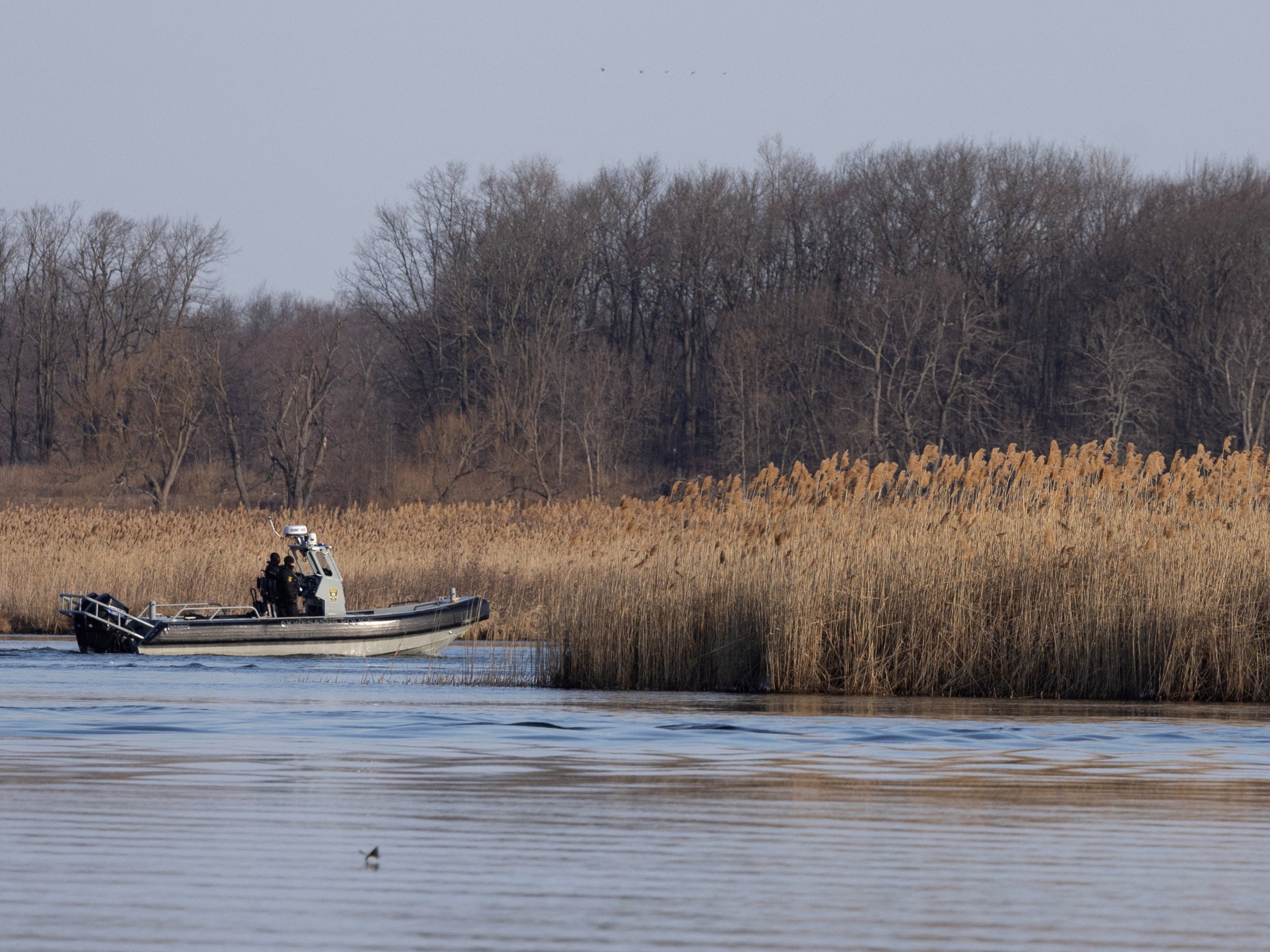 Police search the marshland where bodies were found in Akwesasne, Quebec, Canada March 31, 2023. REUTERS/Christinne Muschi