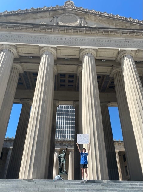 Josh Weisler, 24, stands alone near the Tennessee State Capitol after hundreds attended a gun rally on Thursday