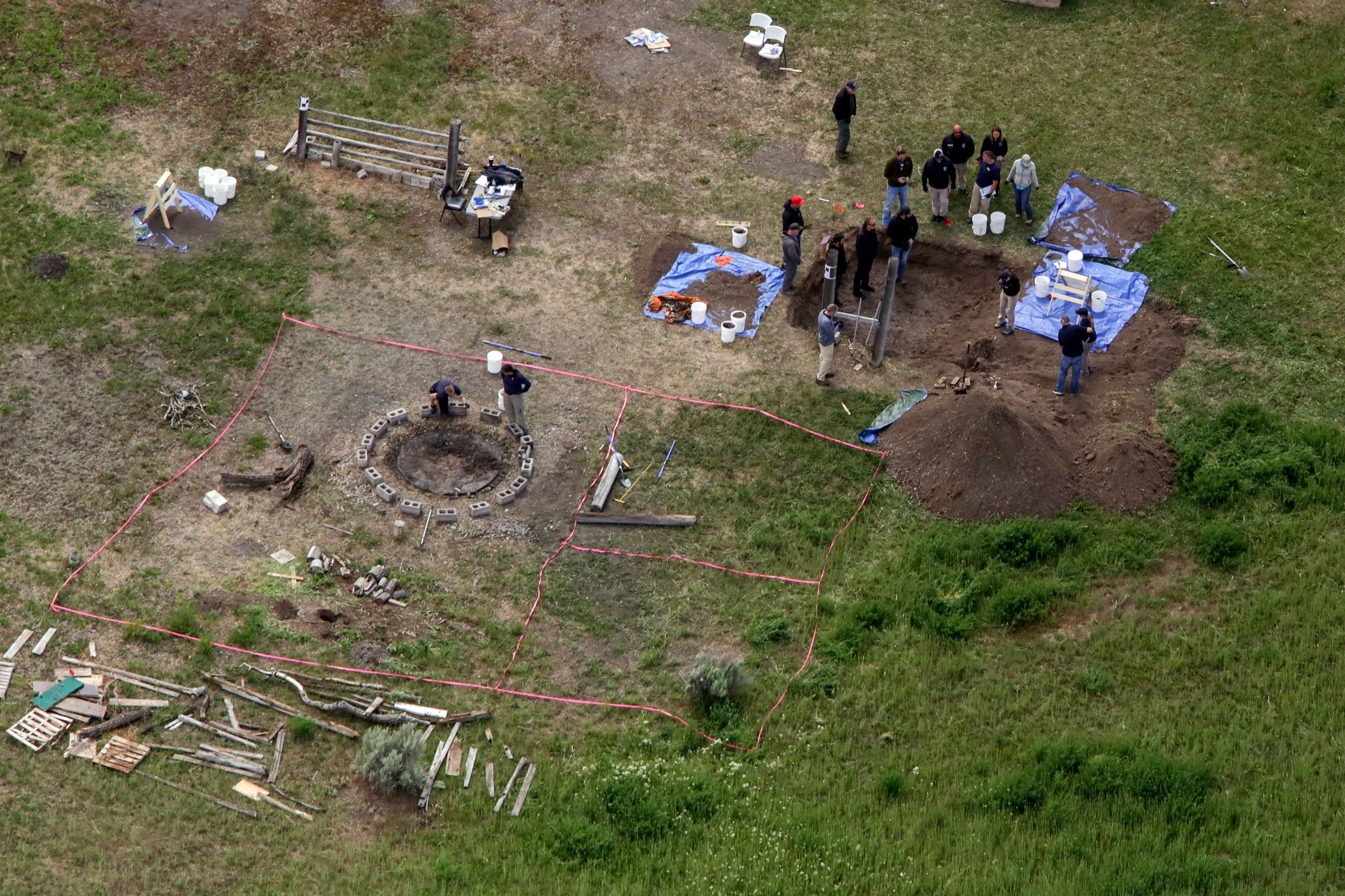 Investigators are seen digging in Chad Daybell’s yard on the day the children were found