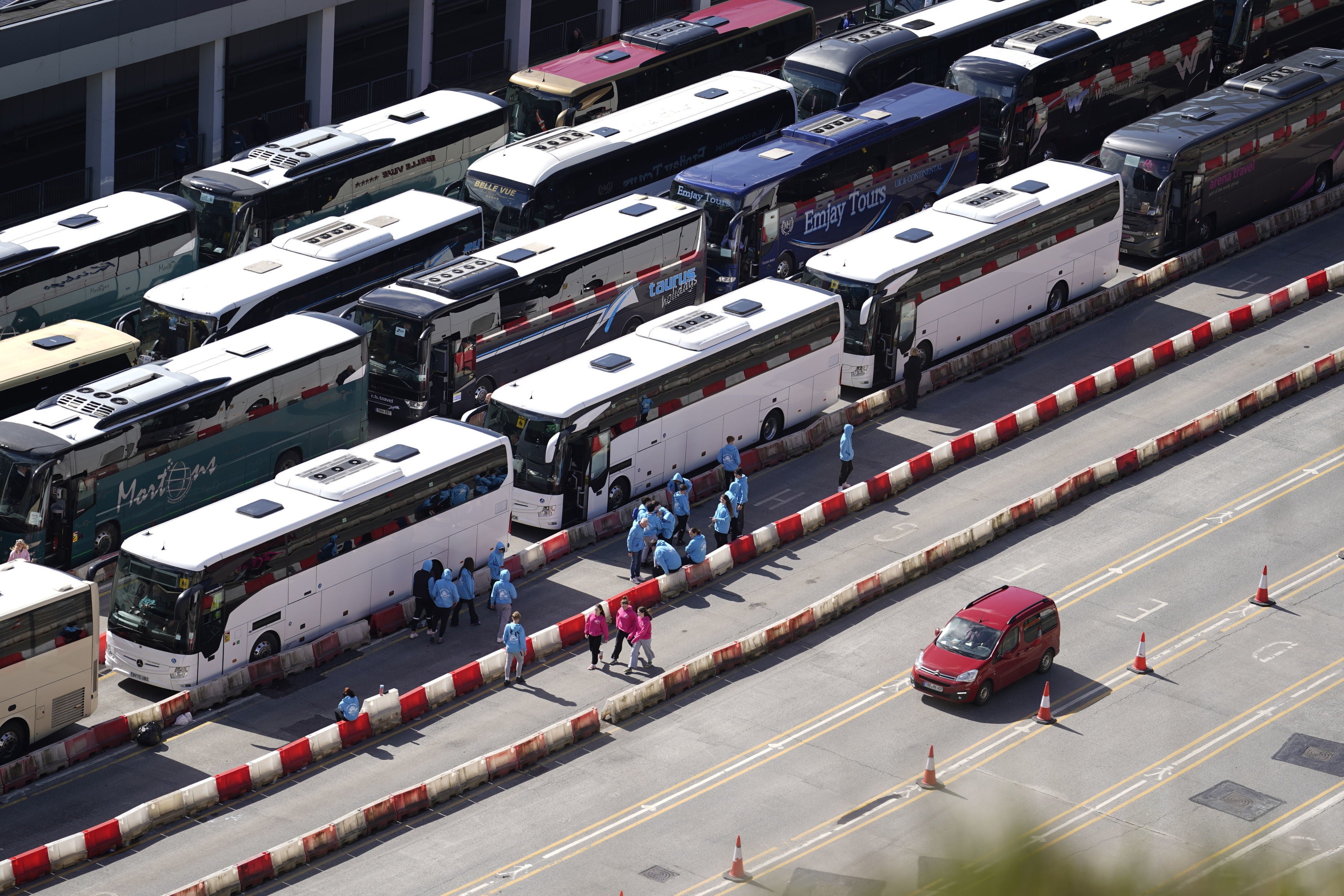 Coaches wait to enter the Port of Dover in Kent after extra sailings were run overnight to try and clear the backlog which has left passengers stuck in Easter traffic for hours