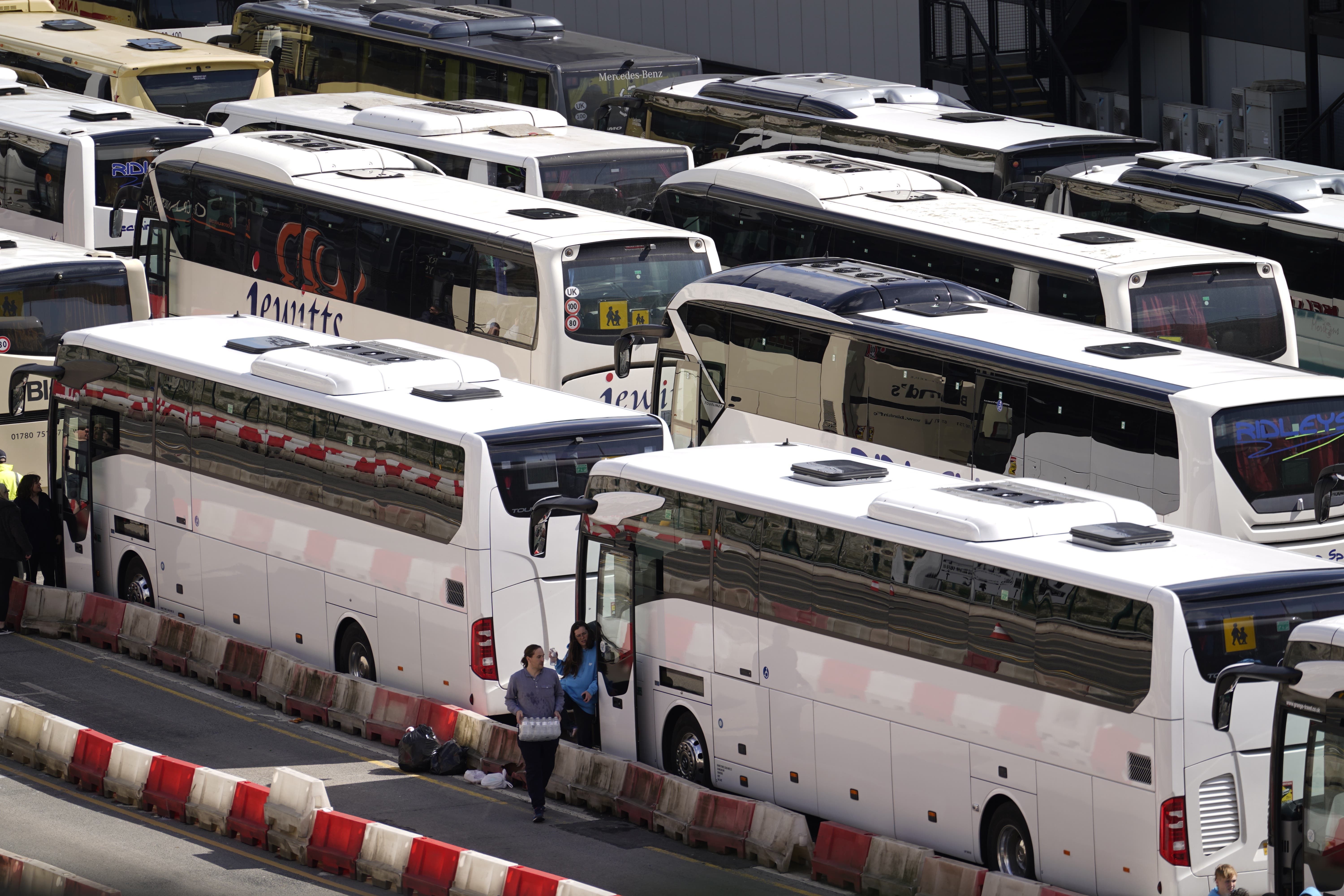 Coaches wait to enter the Port of Dover in Kent after extra sailings were run overnight to try to clear the backlog (PA)