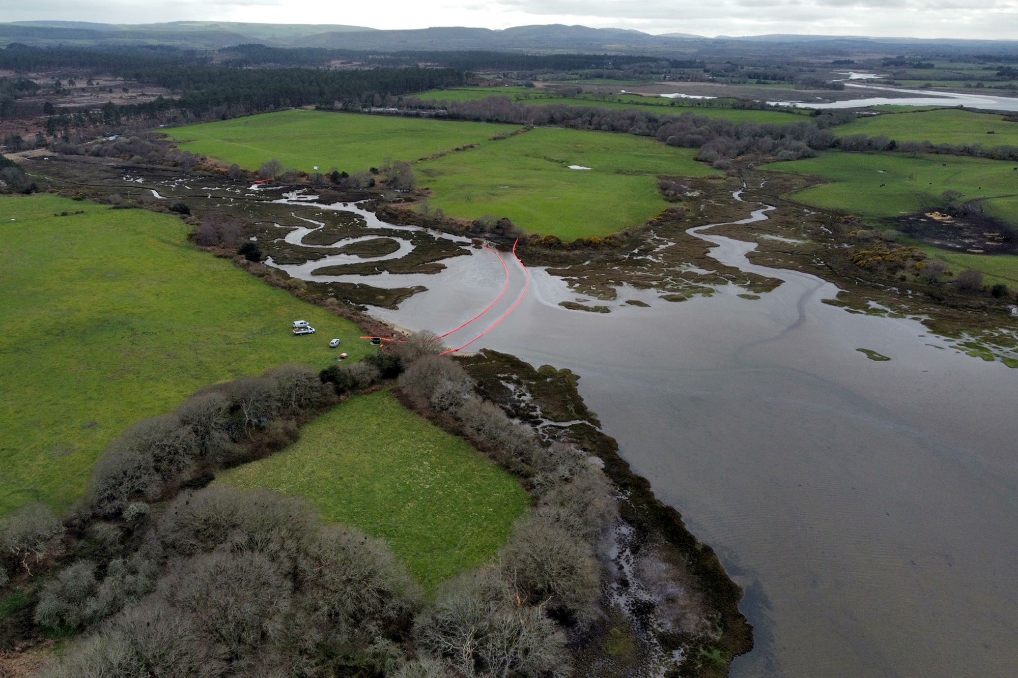 Oil is visible in the water of Poole Harbour, Dorset, following an oil leak from a pipeline at an onshore oil field at the weekend. Picture date: Monday March 27, 2023.