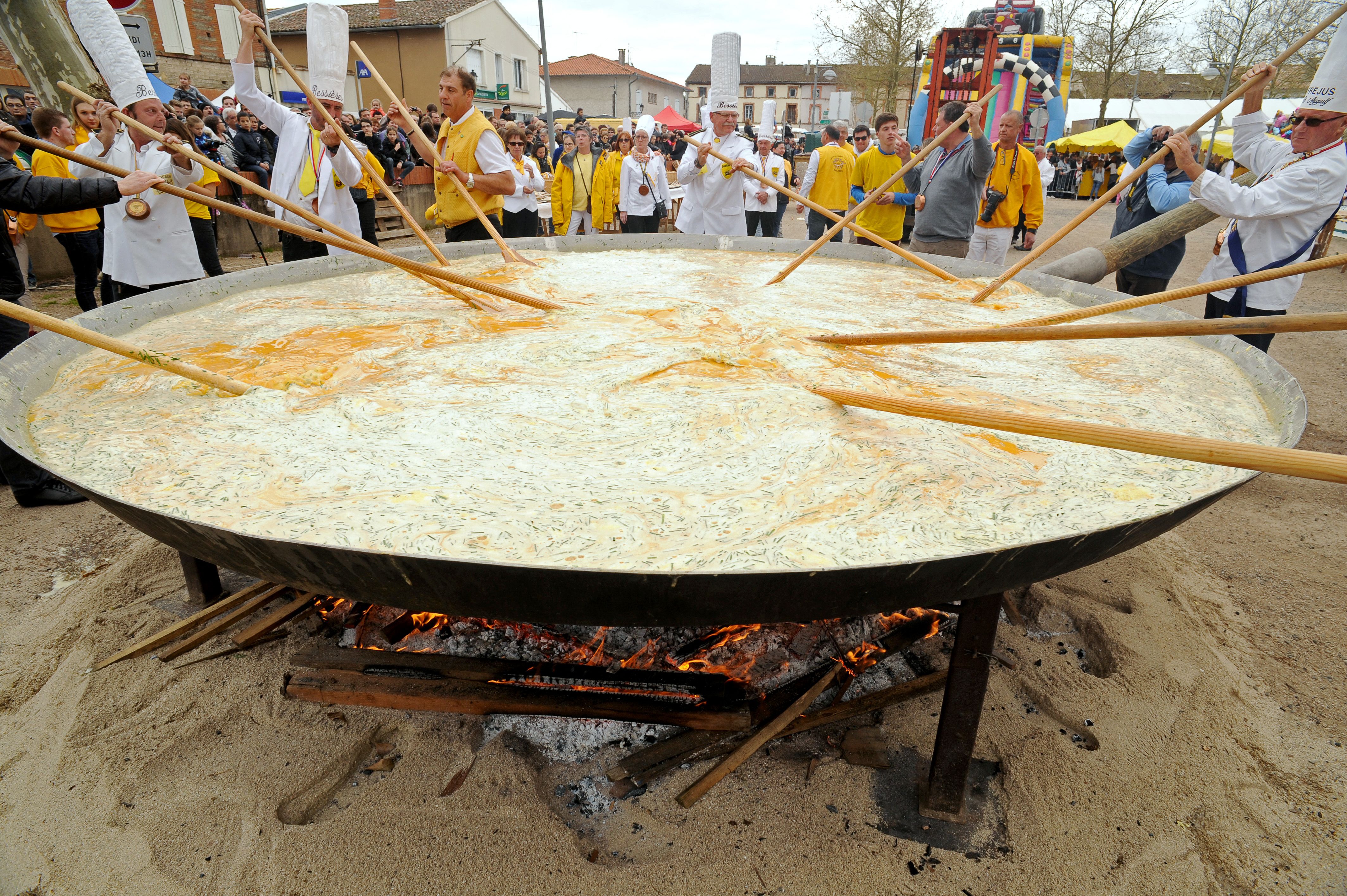 Members of the World Brotherhood of the Knights of the Giant Omelette of Bessières stir their oversize omelette during the city’s annual festival in March 2016