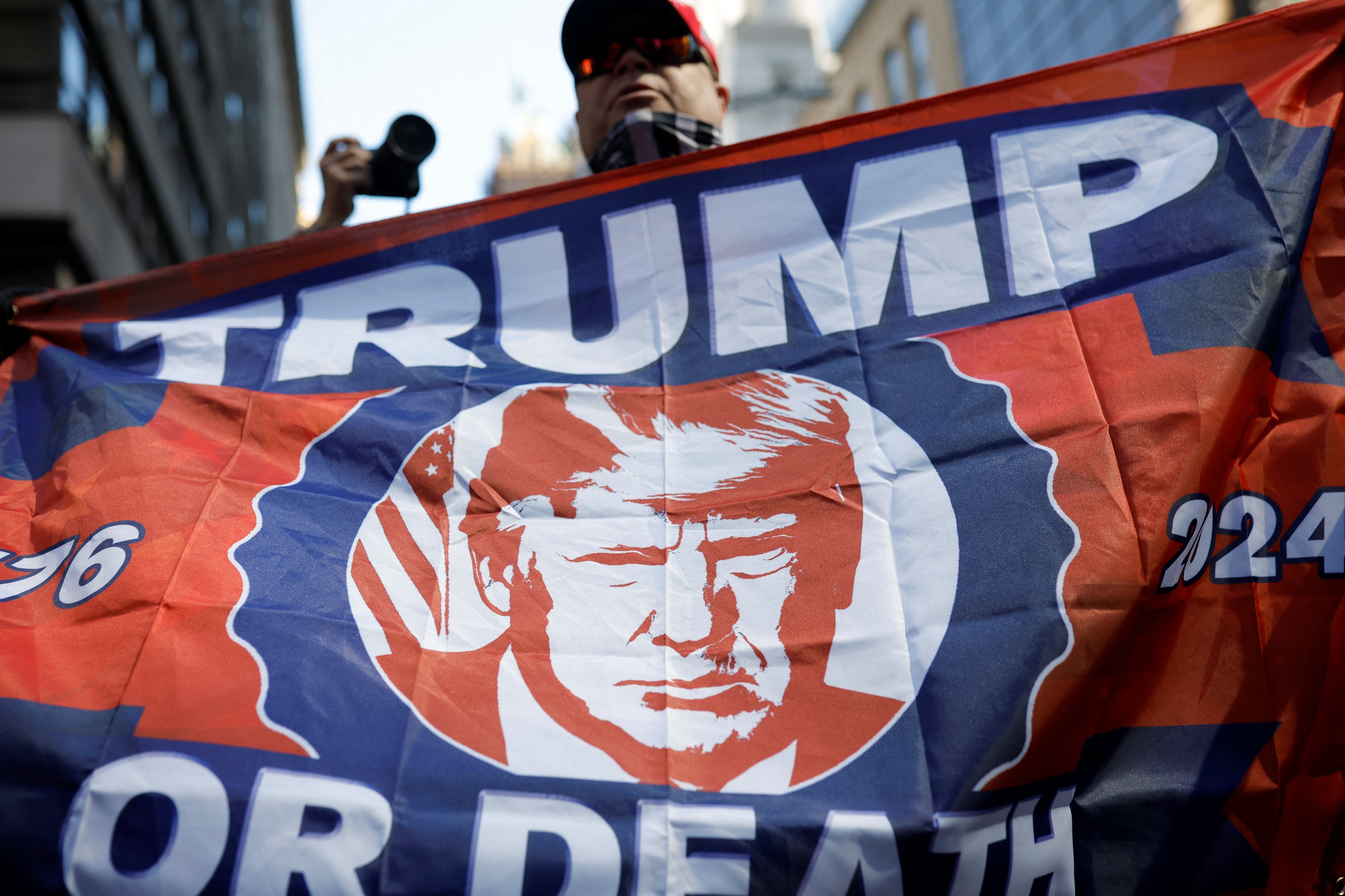 A handful of Trump supporters stood outside Trump Tower on Fifth Avenue on 3 April to welcome the former president as he arrives in New York to face criminal charges.