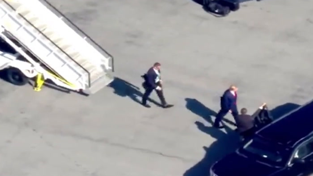 Donald Trump exits his 757 at New York’s La Guardia Airport and is met by Secret Service agents.