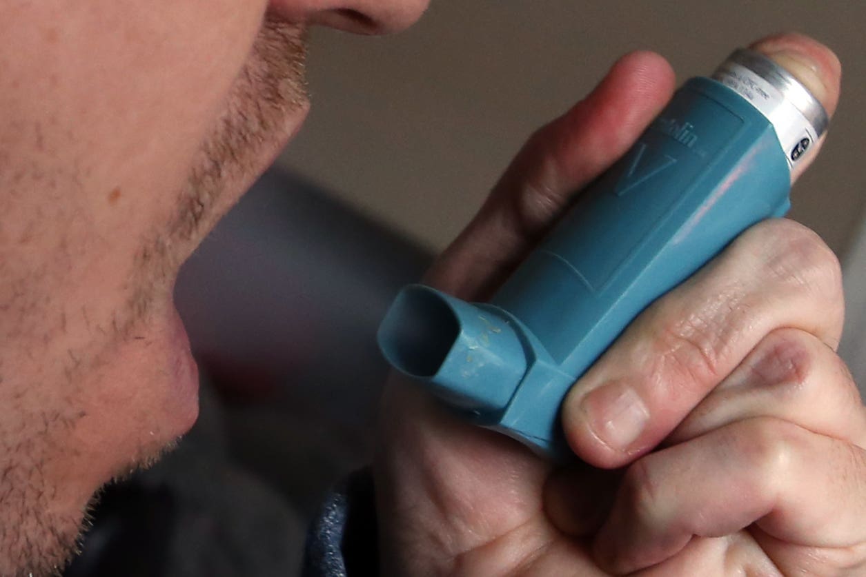 A person using an inhaler for the treatment of asthma (PA)