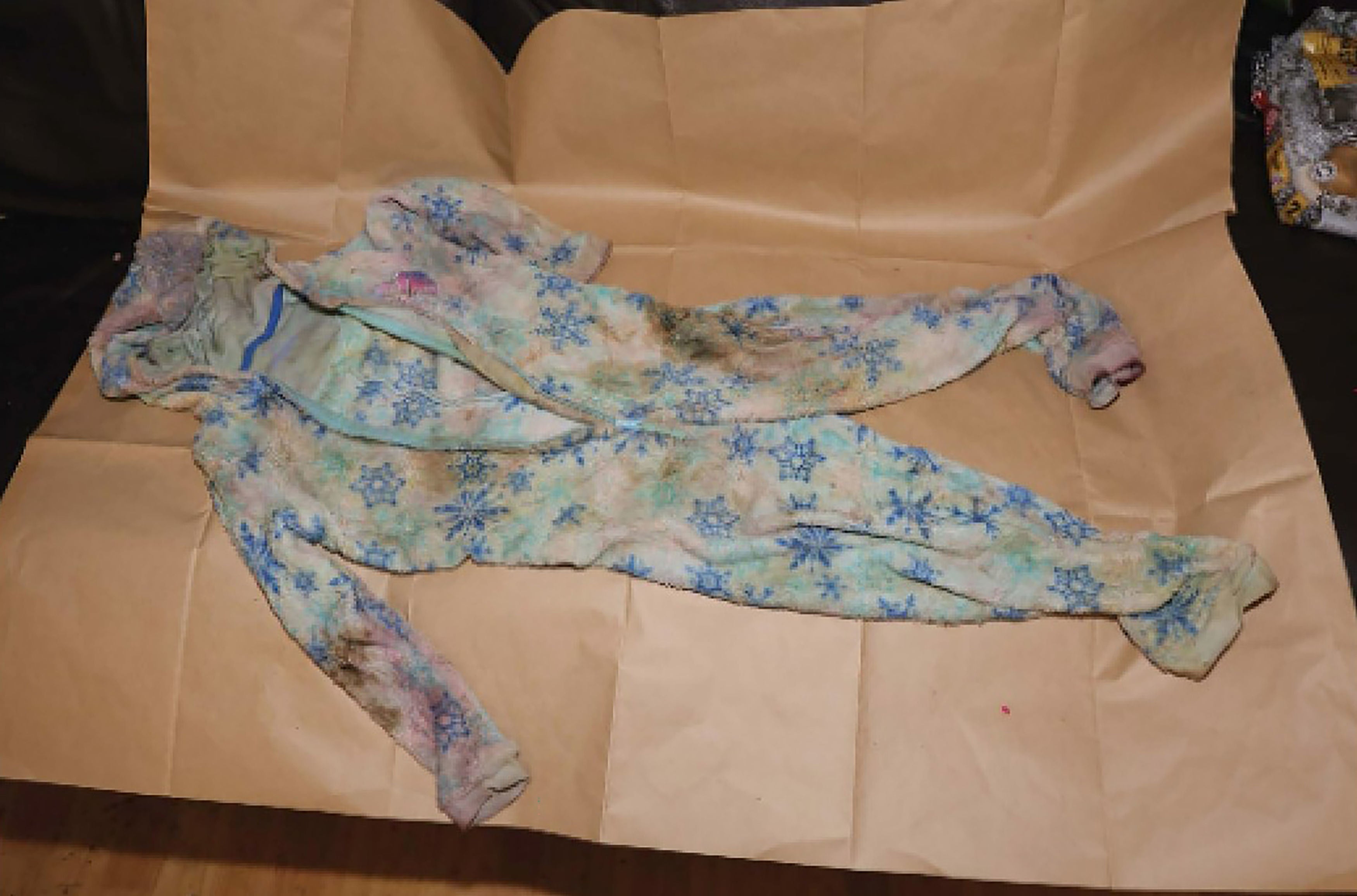 Police crime scene investigators recovered a wet, vomit and blood-stained grey onesie from their home