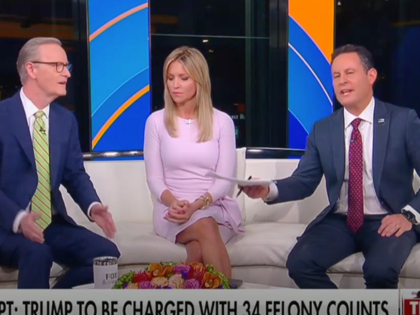 Fox News hosts Doug Doocy and Brian Kilmeade spar in a recent segment on Fox & Friends. Host Ainsley Earhardt, middle, observes.