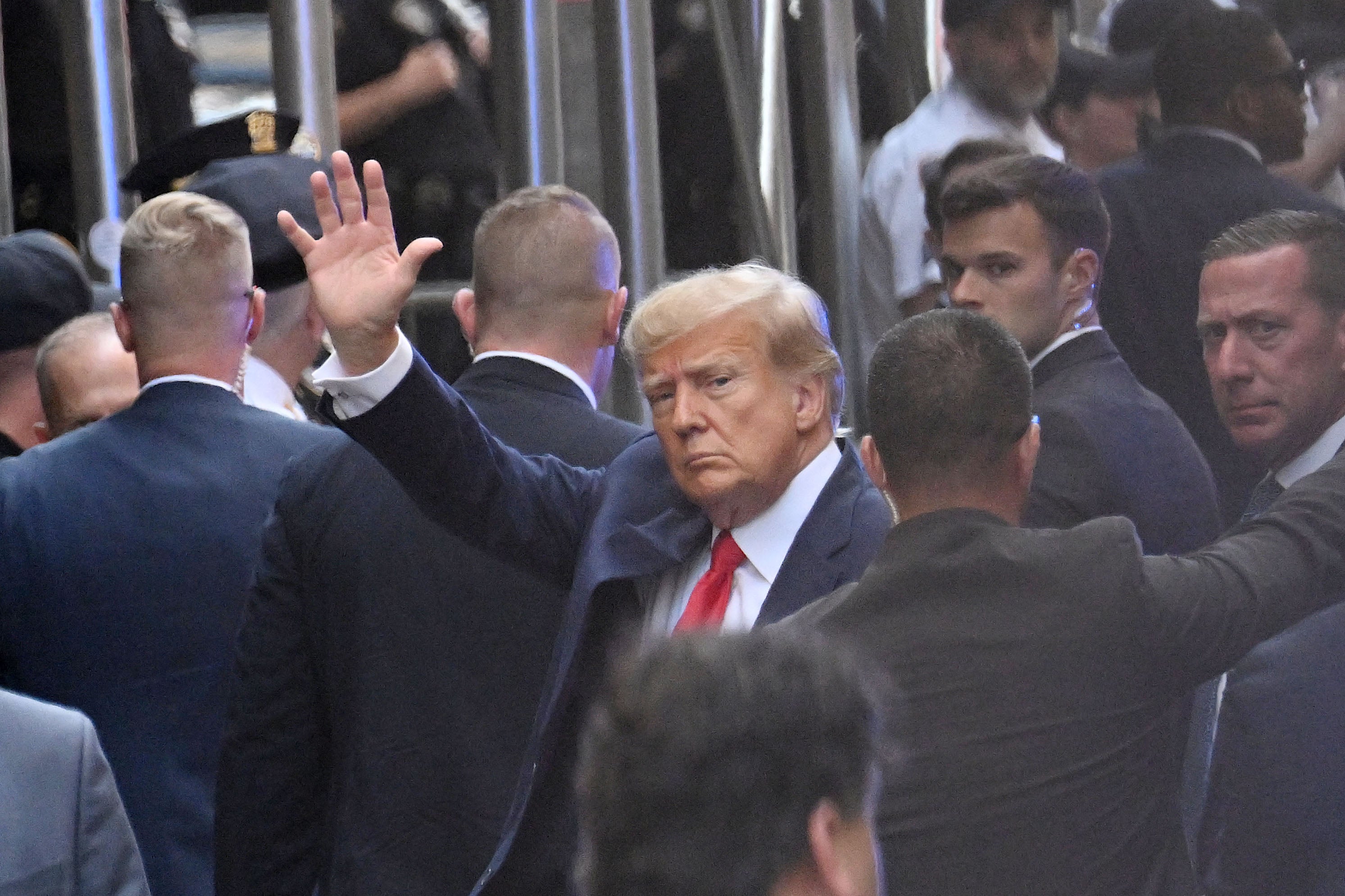 Donald Trump waves to supporters as he arrives at the Manhattan courthouse on Tuesday afternoon
