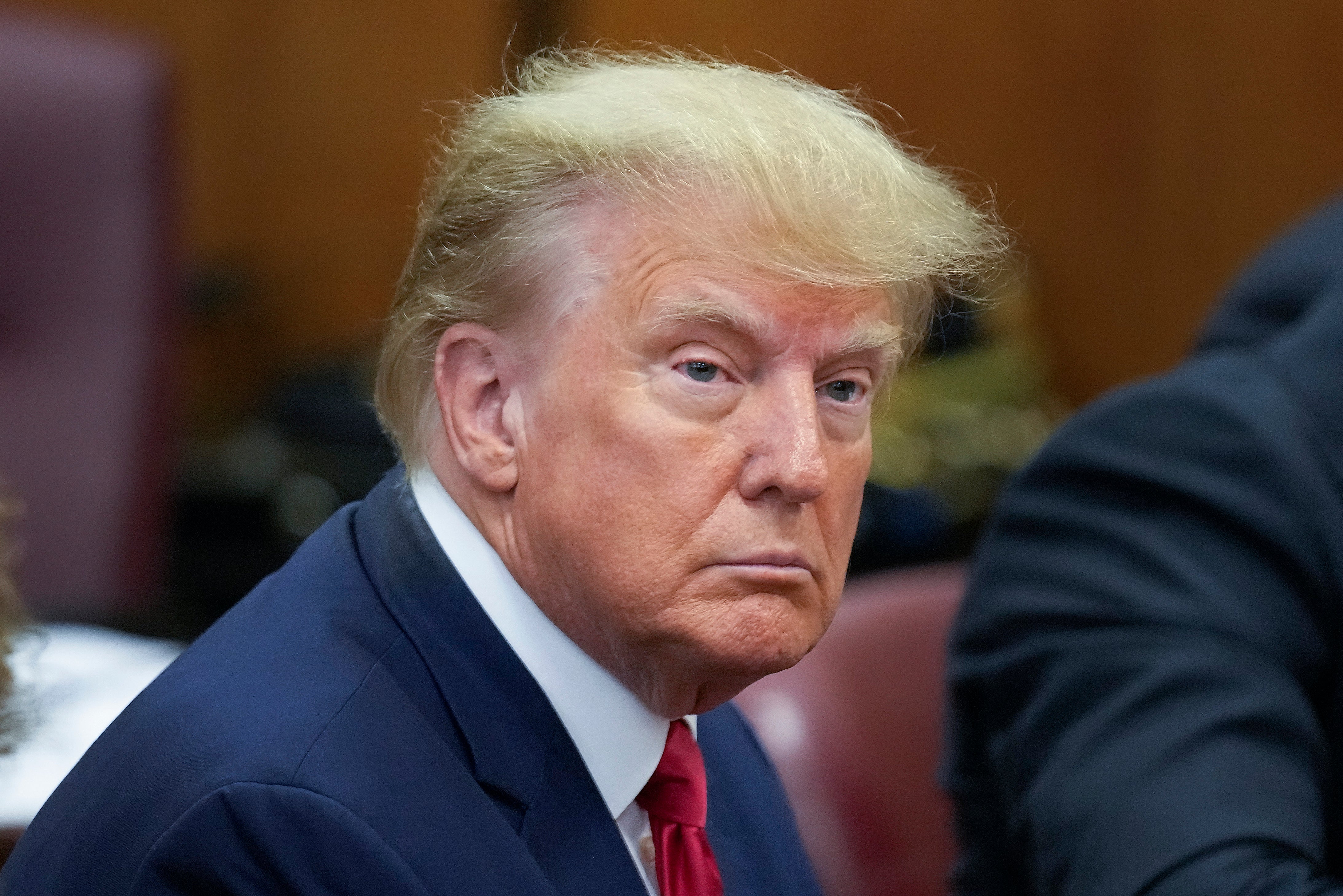 Former US President Donald Trump sits at the defence table with his defence team in a Manhattan court on 4 April 2023 in New York City