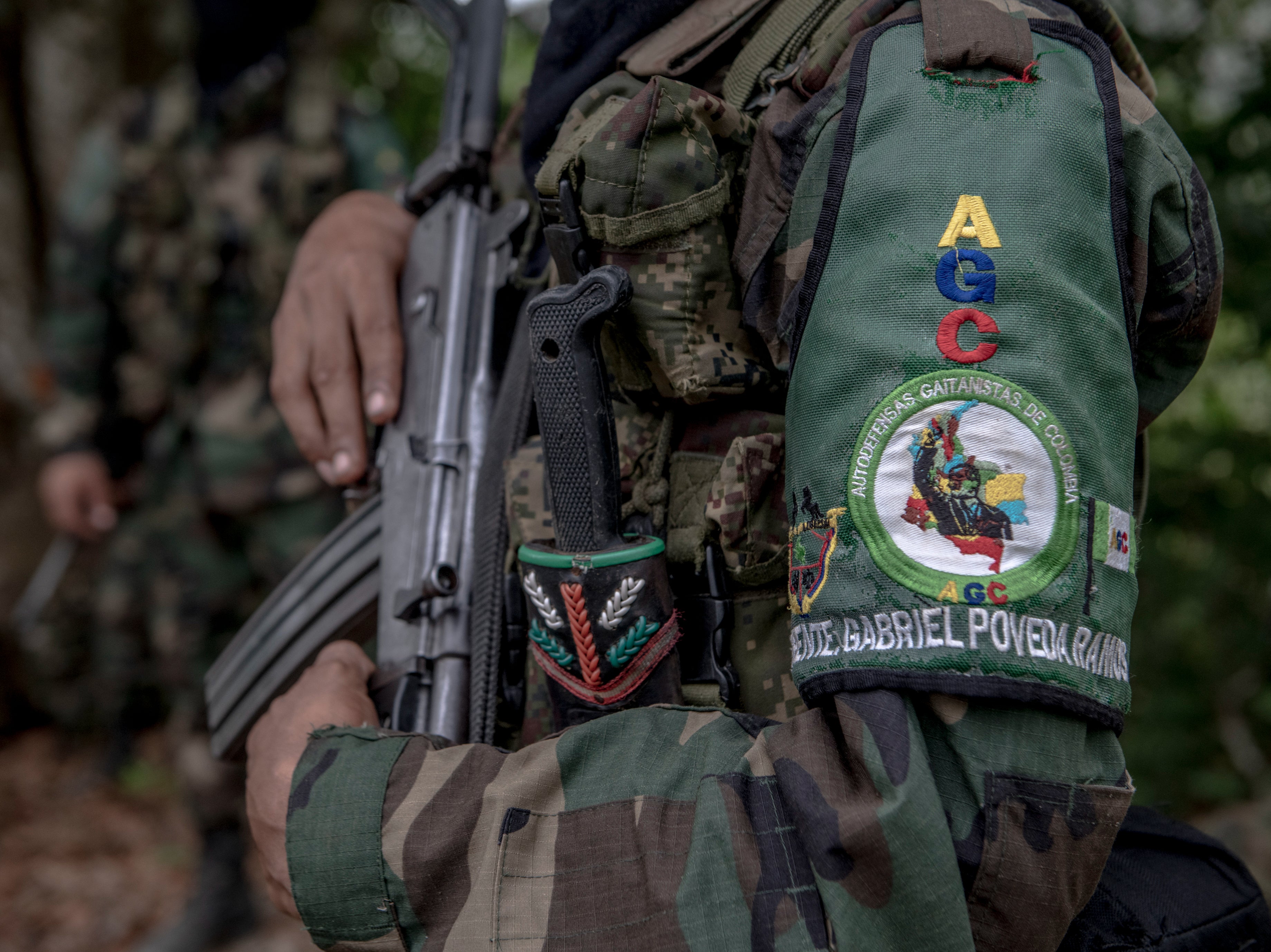 A unit member wears an armband decorated with AGC symbols