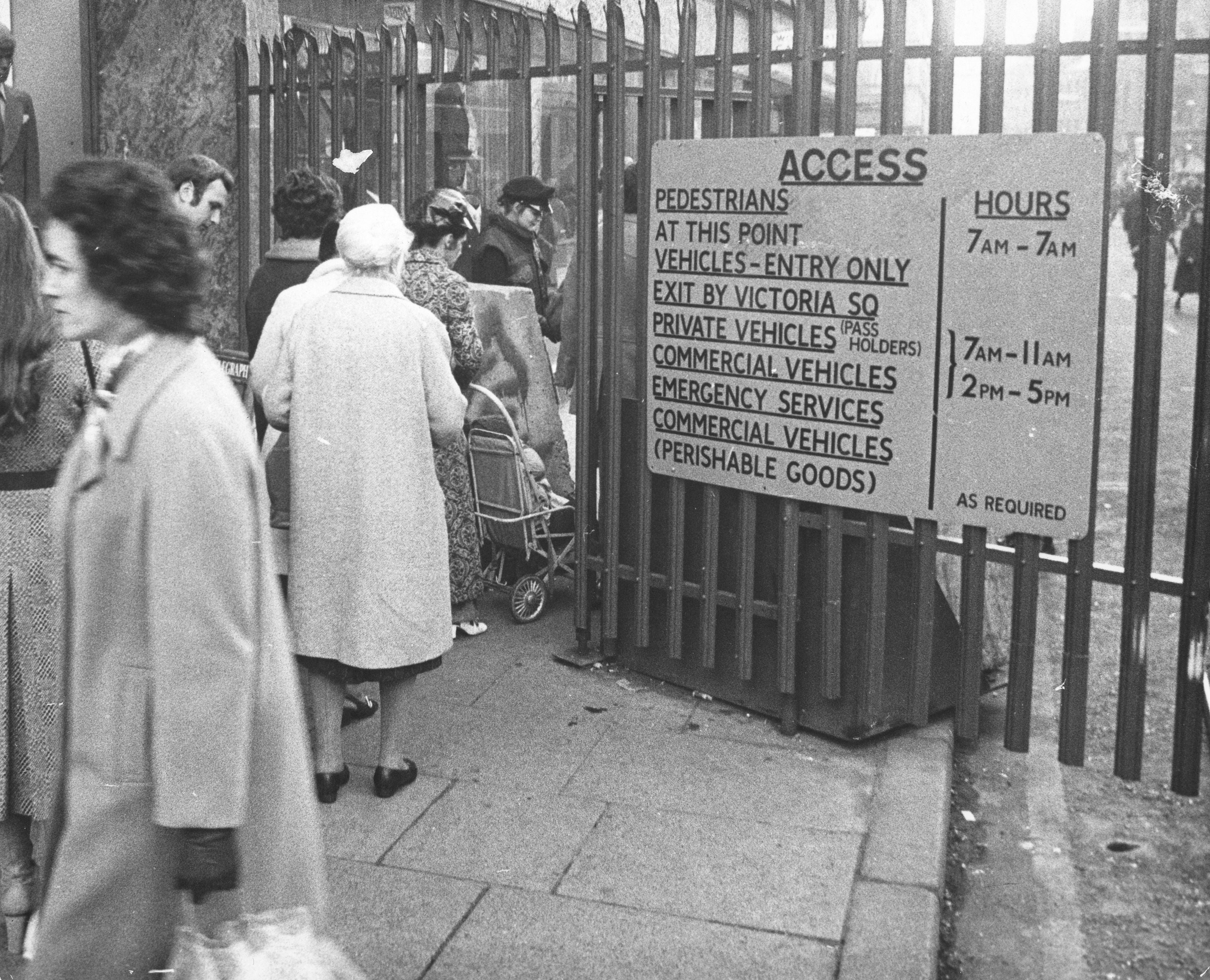 Belfast residents queuing up at a checkpoint leading out of the city's shopping area