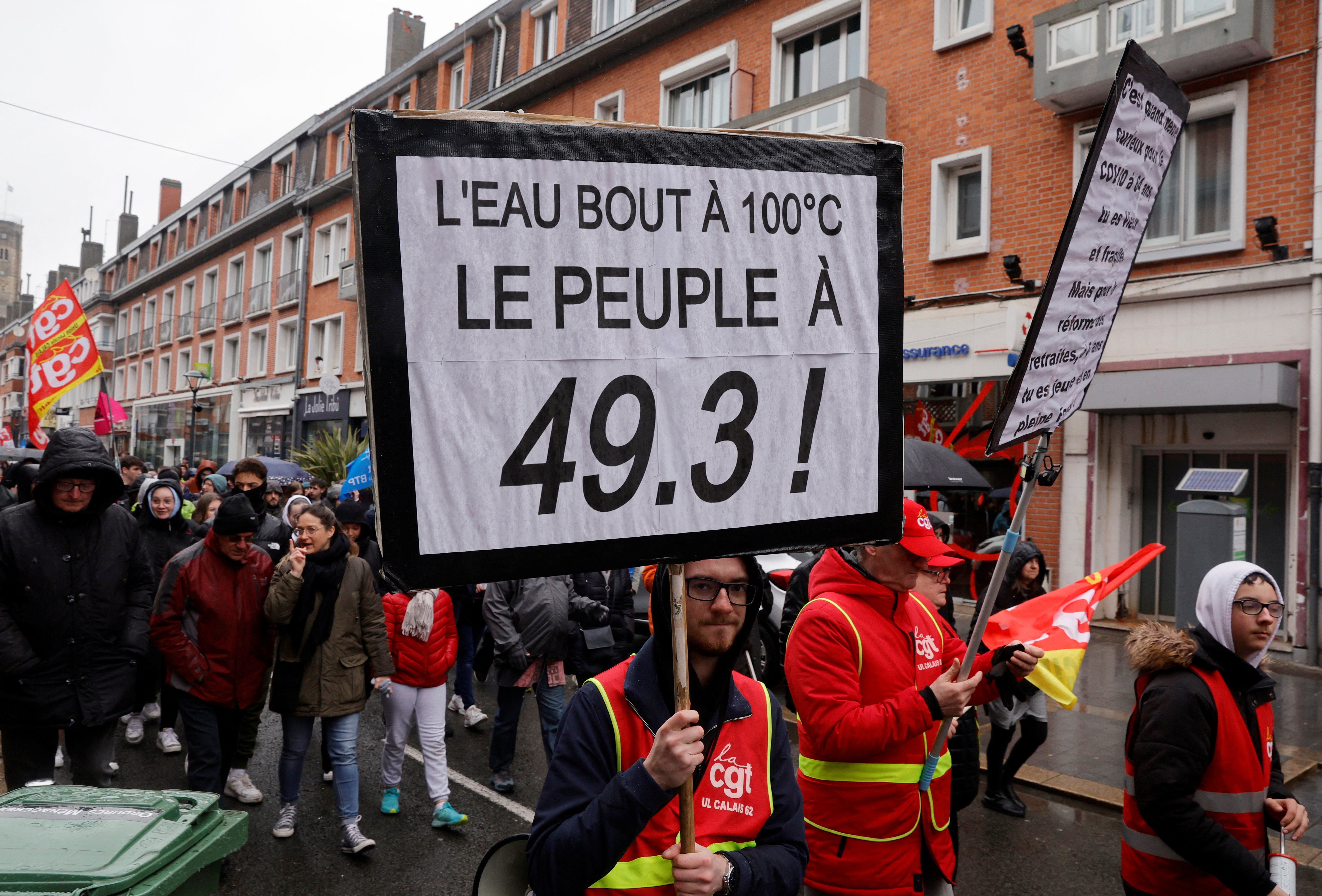 A protester holds a placard during a demonstration as part of the eleventh day of nationwide strikes in Calais