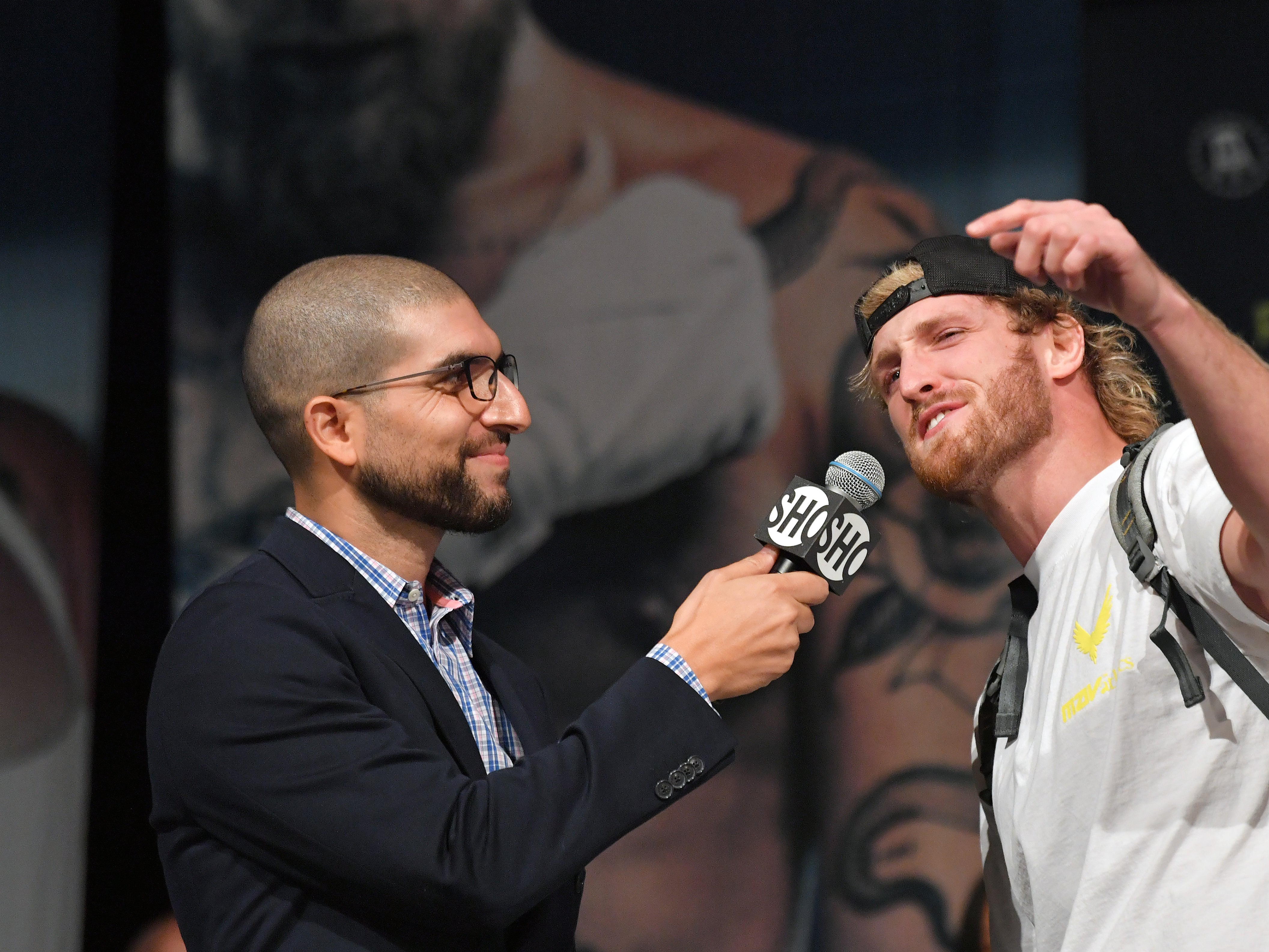 Helwani (left) speaking with Logan Paul in 2021