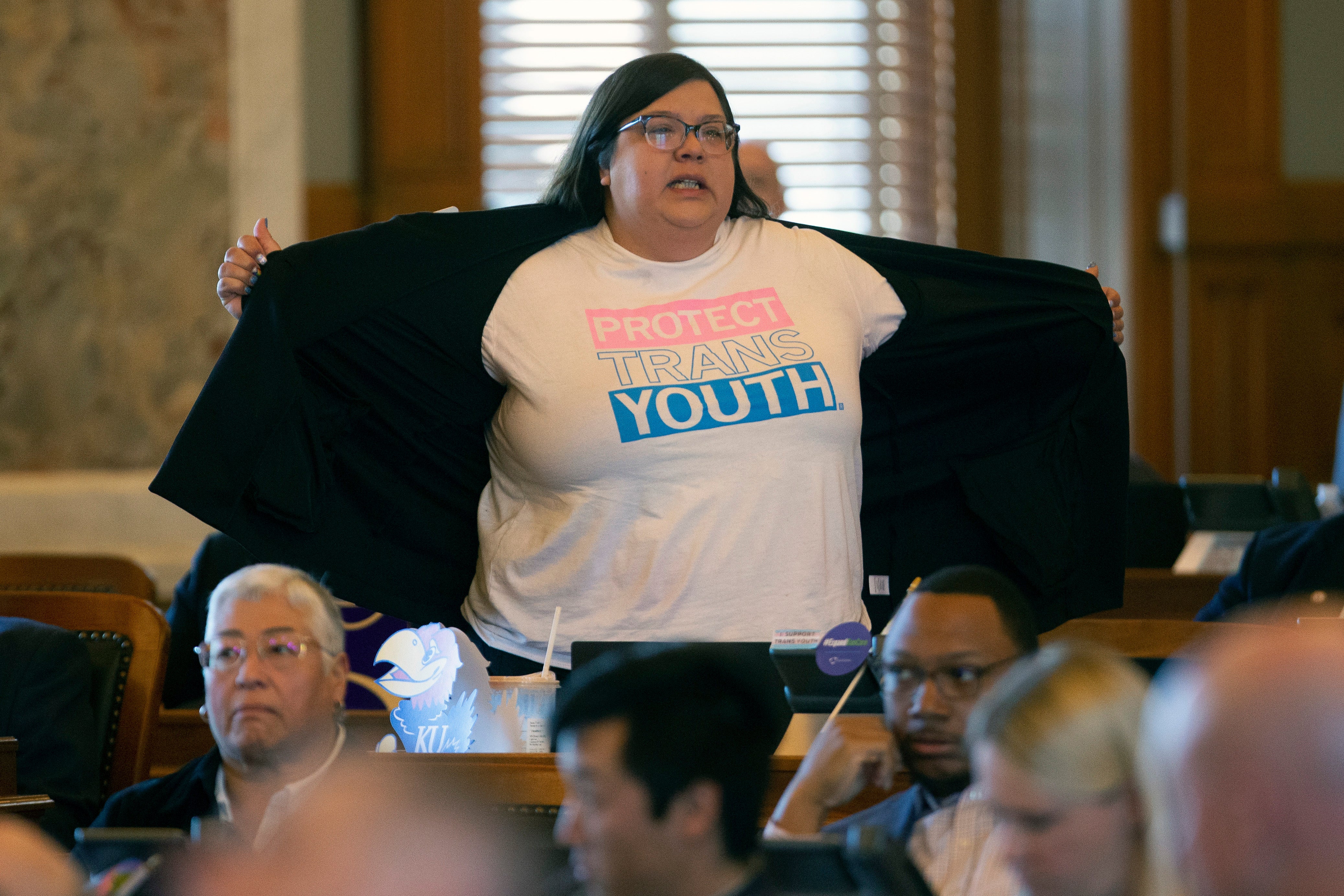 Kansas state Rep Heather Meyer protested a vote to override the governor’s veto of a bill banning trans women and girls from competing in school sports on 5 April.