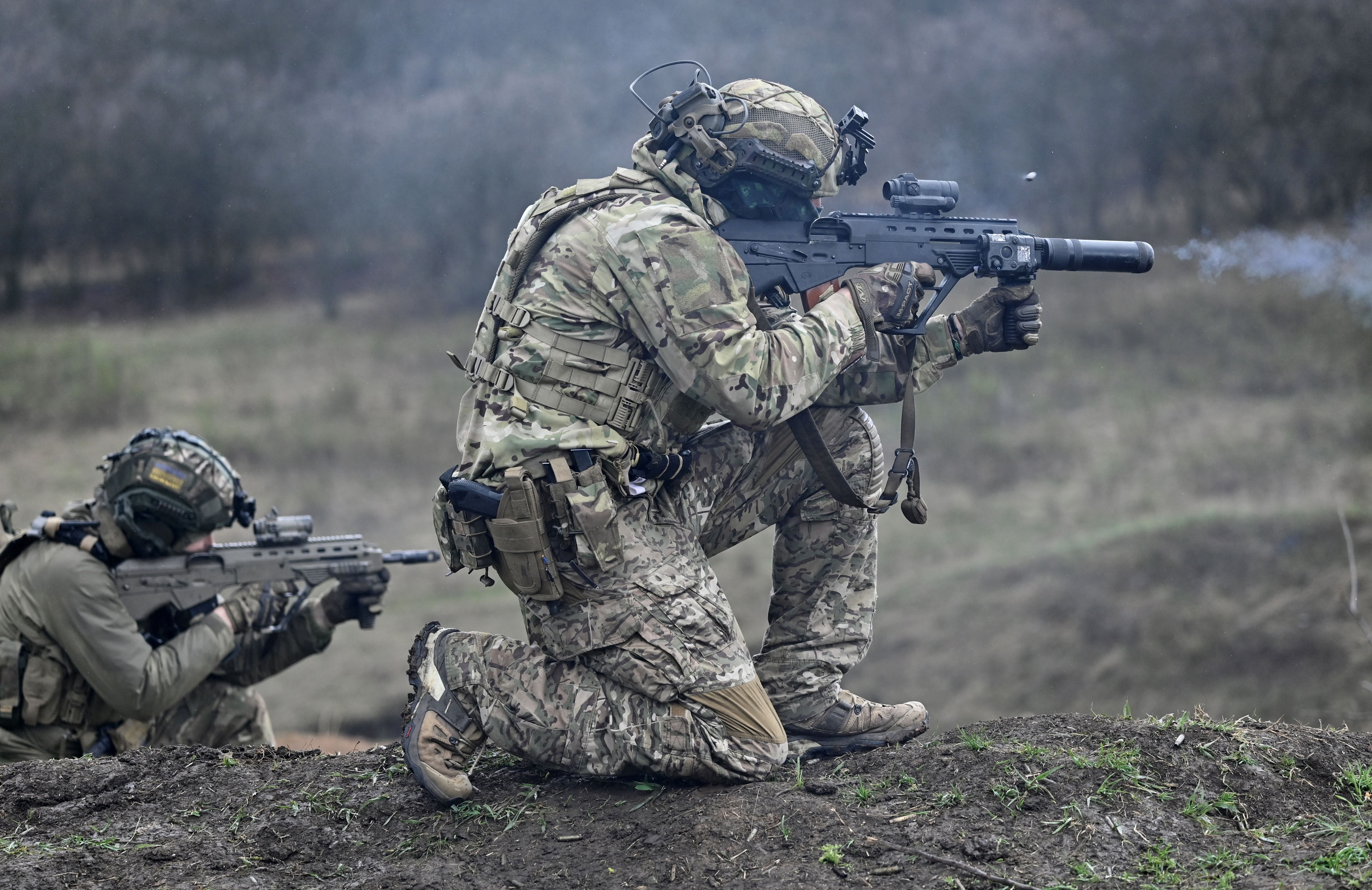 A Ukrainian Special Forces serviceman (R) fires a Ukrainian made Malyuk assault rifle during a training exercise in Donetsk region amid the Russian invasion of Ukraine